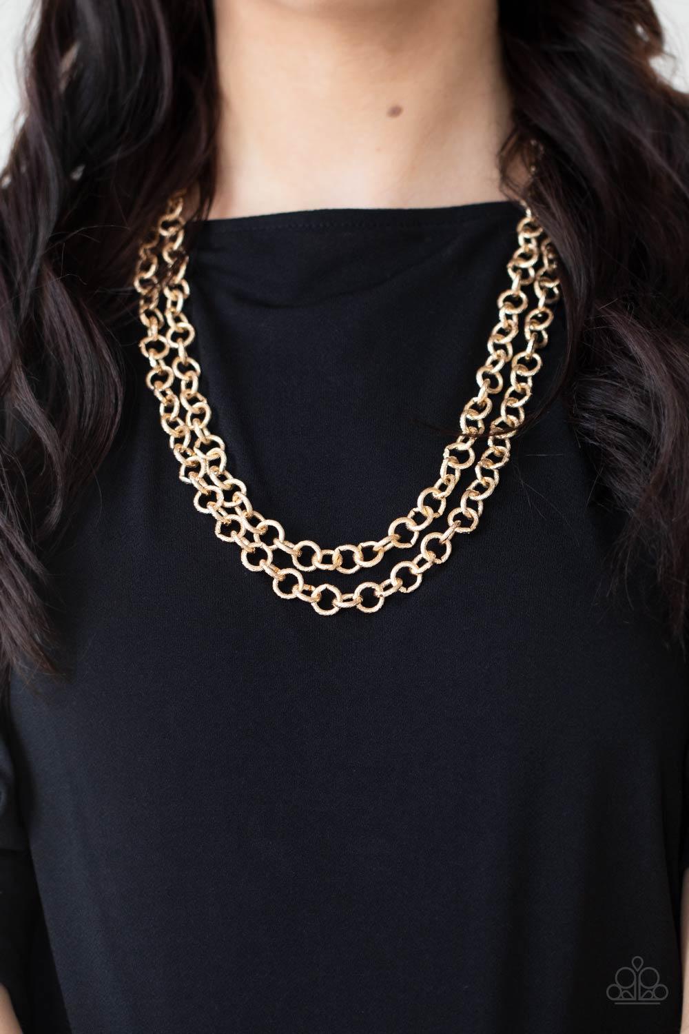 Paparazzi Accessories Grunge Goals - Gold A seemingly infinite collection of textured shiny gold links connect into two dramatic rows across the chest, creating an intense industrial display. Features an adjustable clasp closure. Sold as one individual ne