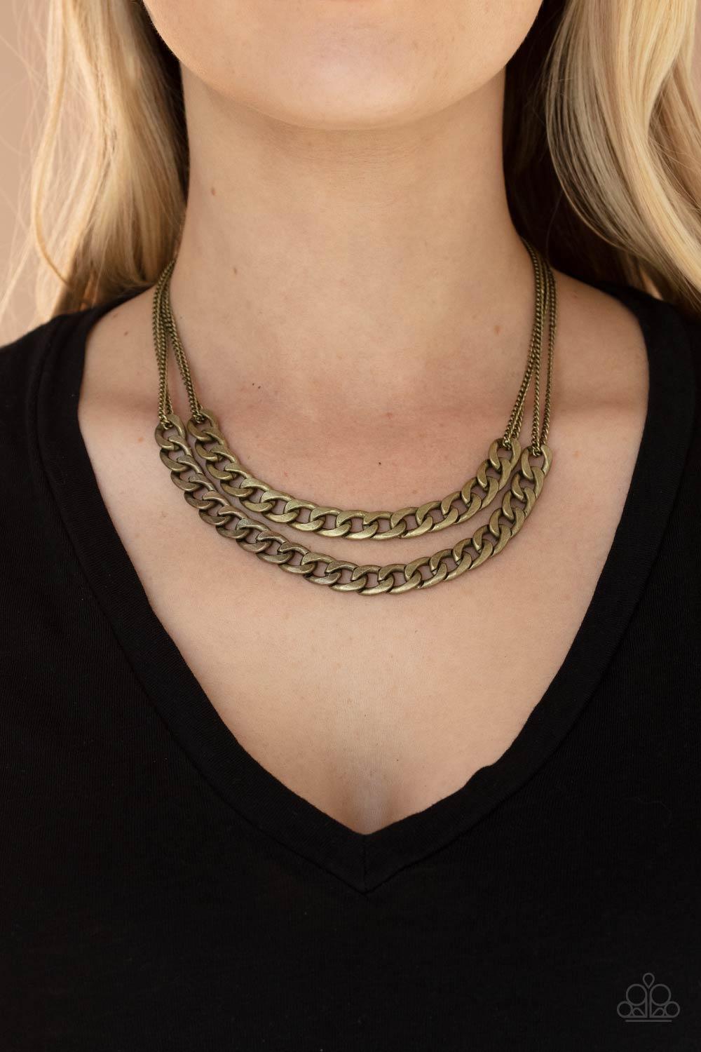 Paparazzi Accessories Urban Culture - Brass Two sections of chunky brass curb chain attach to doubled brass chains below the collar, creating an intense industrial centerpiece. Features an adjustable clasp closure. Sold as one individual necklace. Include