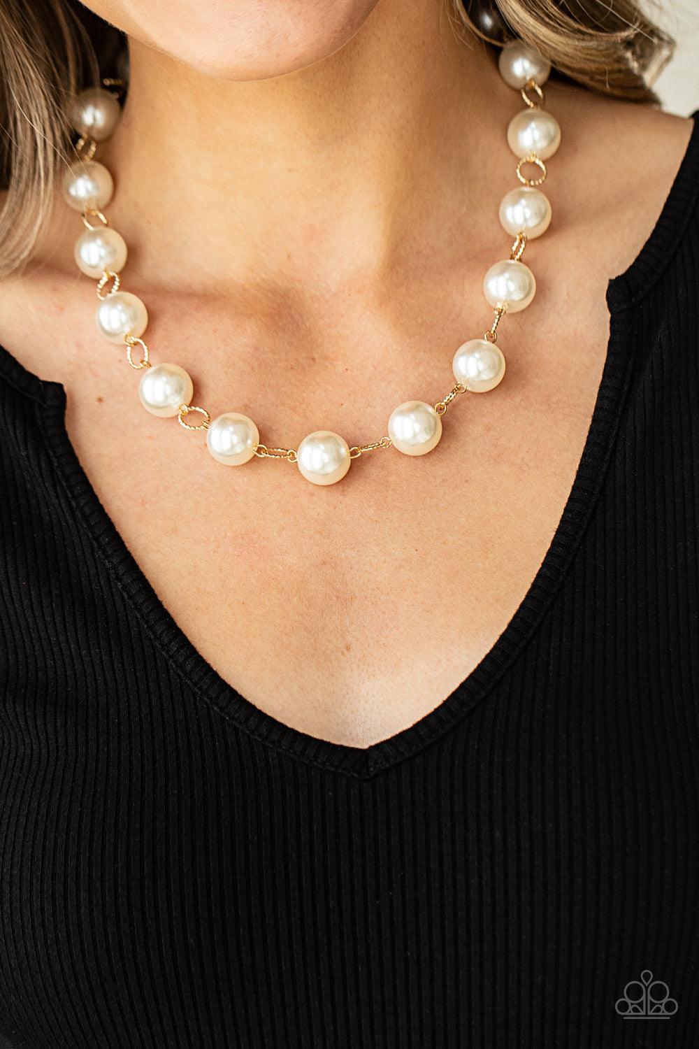 Paparazzi Accessories Ensconced in Elegance - Gold Textured gold rings and oversized white pearls delicately link into a bubbly statement piece below the collar. Features an adjustable clasp closure. Sold as one individual necklace. Includes one pair of m