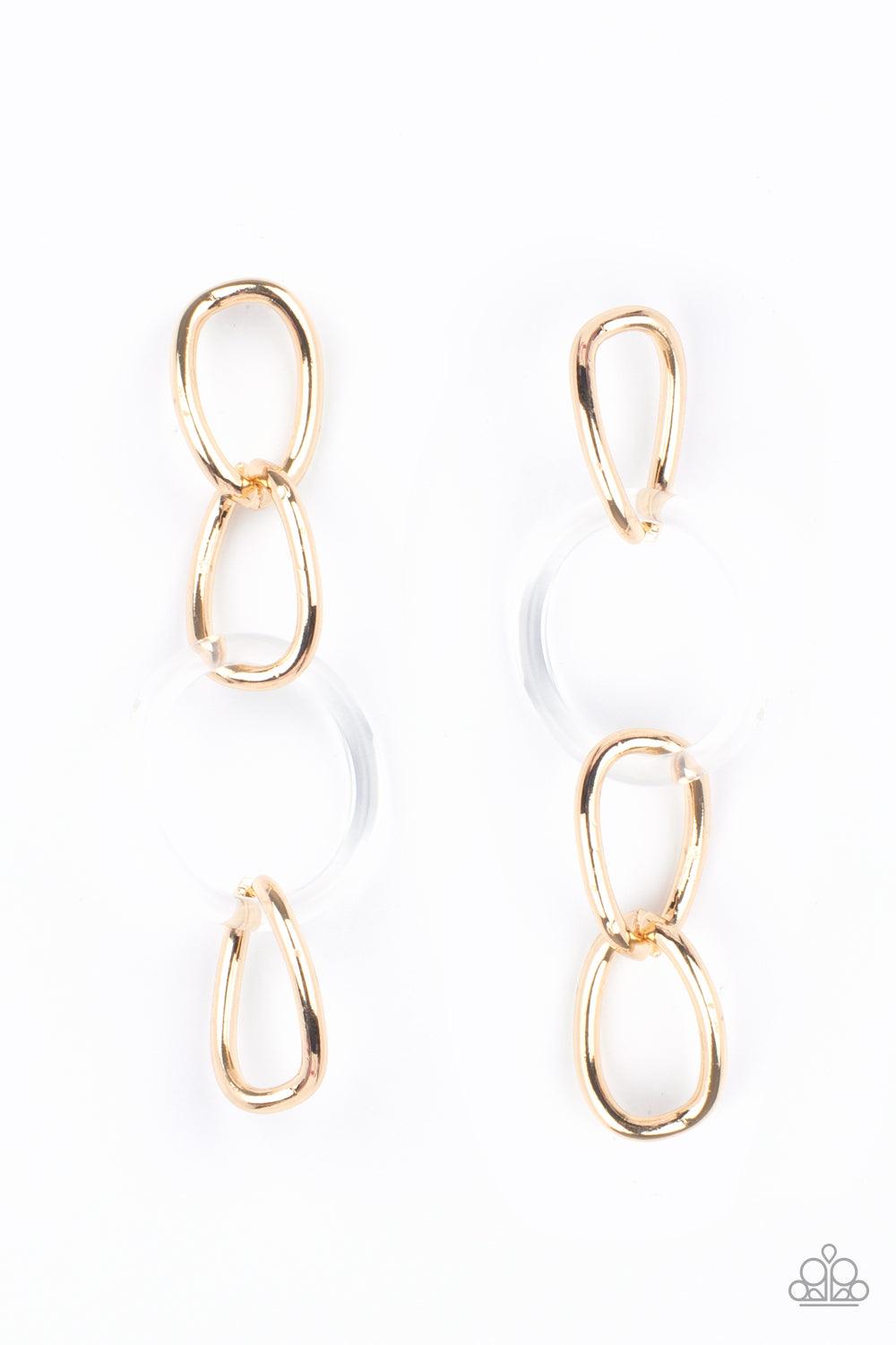 Paparazzi Accessories Talk In Circles - Gold Bright gold oversized links, interrupted by a single large clear acrylic ring, fall from the ear in linked succession for an on-trend fashion statement. Earring attaches to a standard post fitting. Sold as one