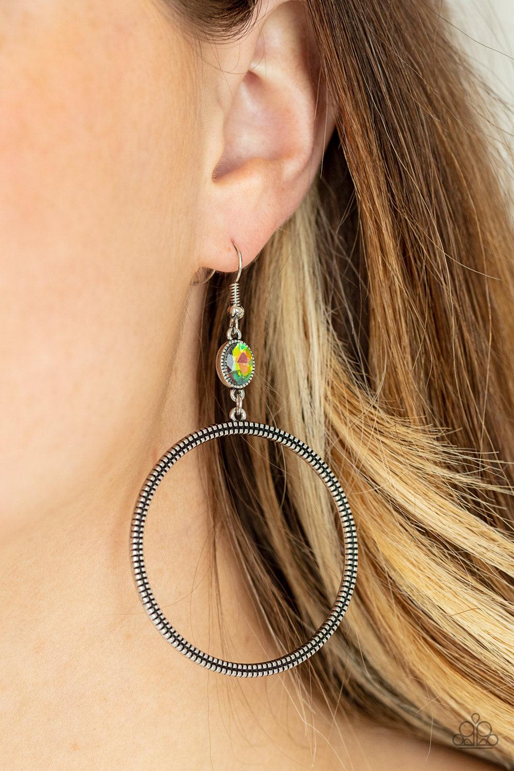 Paparazzi Accessories Work That Circuit - Multi A slim oversized silver ring, highlighted by two concentric circles of dotted texture, dangles from an oval oil spill gem for an edgy refined look. Earring attaches to a standard fishhook fitting. Sold as on