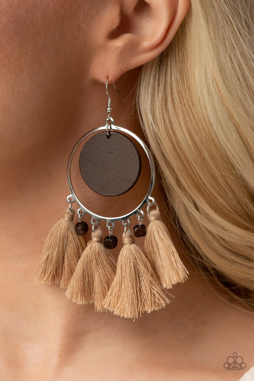 Paparazzi Accessories Yacht Bait - Brown A wooden disc swings from the top of a shiny silver hoop that is adorned in dainty wooden cube beads and Desert Mist threaded tassels, creating an earthy fringe. Earring attaches to a standard fishhook fitting. Sol