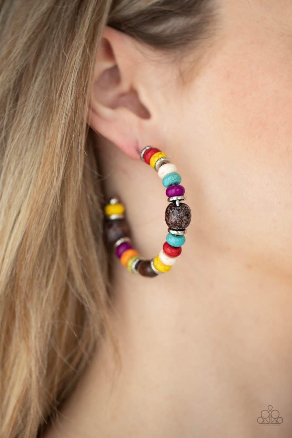 Paparazzi Accessories Definitely Down-To-Earth - Multi An earthy collection of multicolored stone beads, silver discs, and brown wooden beads are delicately threaded along a dainty wire, creating an artisan inspired hoop. Earring attaches to a standard po