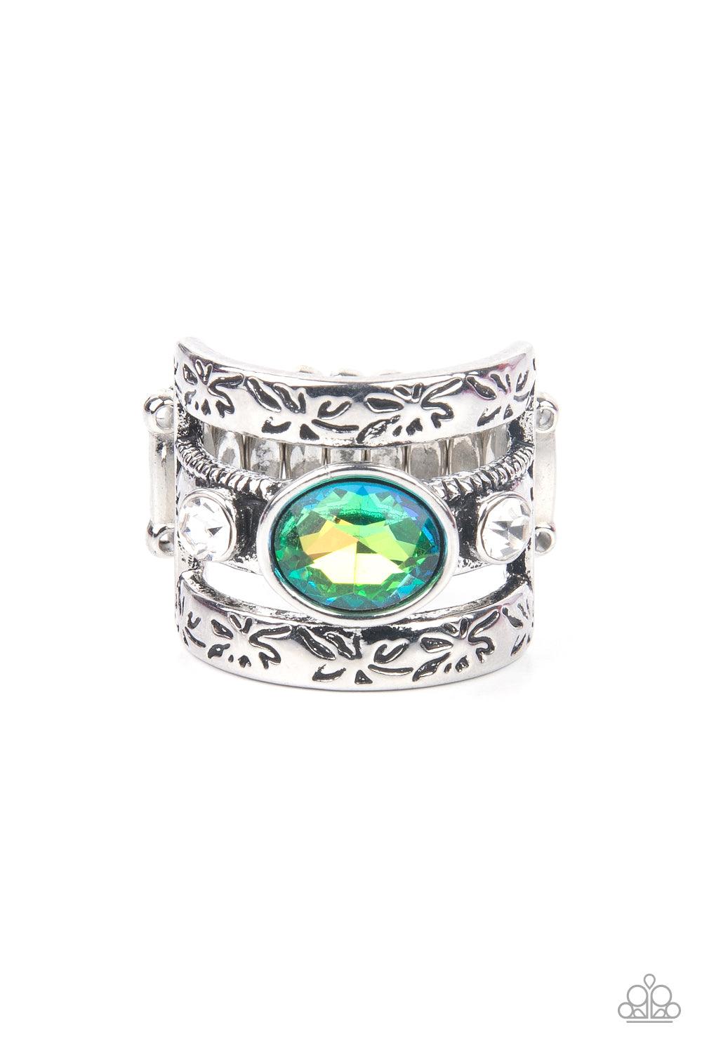Paparazzi Accessories The GLEAMING Tower - Green A gleaming iridescent green oval cut gem sits atop a silver metal bar with smaller white rhinestones resting on either side. Silver bars etched in floral detail on top and bottom create a towering effect ac