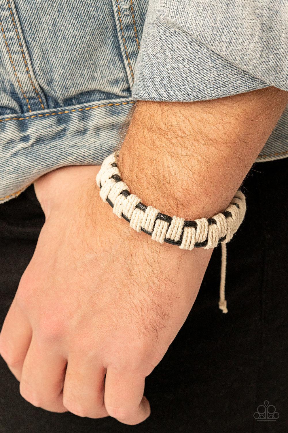 Paparazzi Accessories Rustic Terrain - Black Sections of rustic white cording interweave and knot around three rows of black leather cords, creating an earthy checkered pattern around the wrist. Features an adjustable sliding knot closure. Sold as one ind