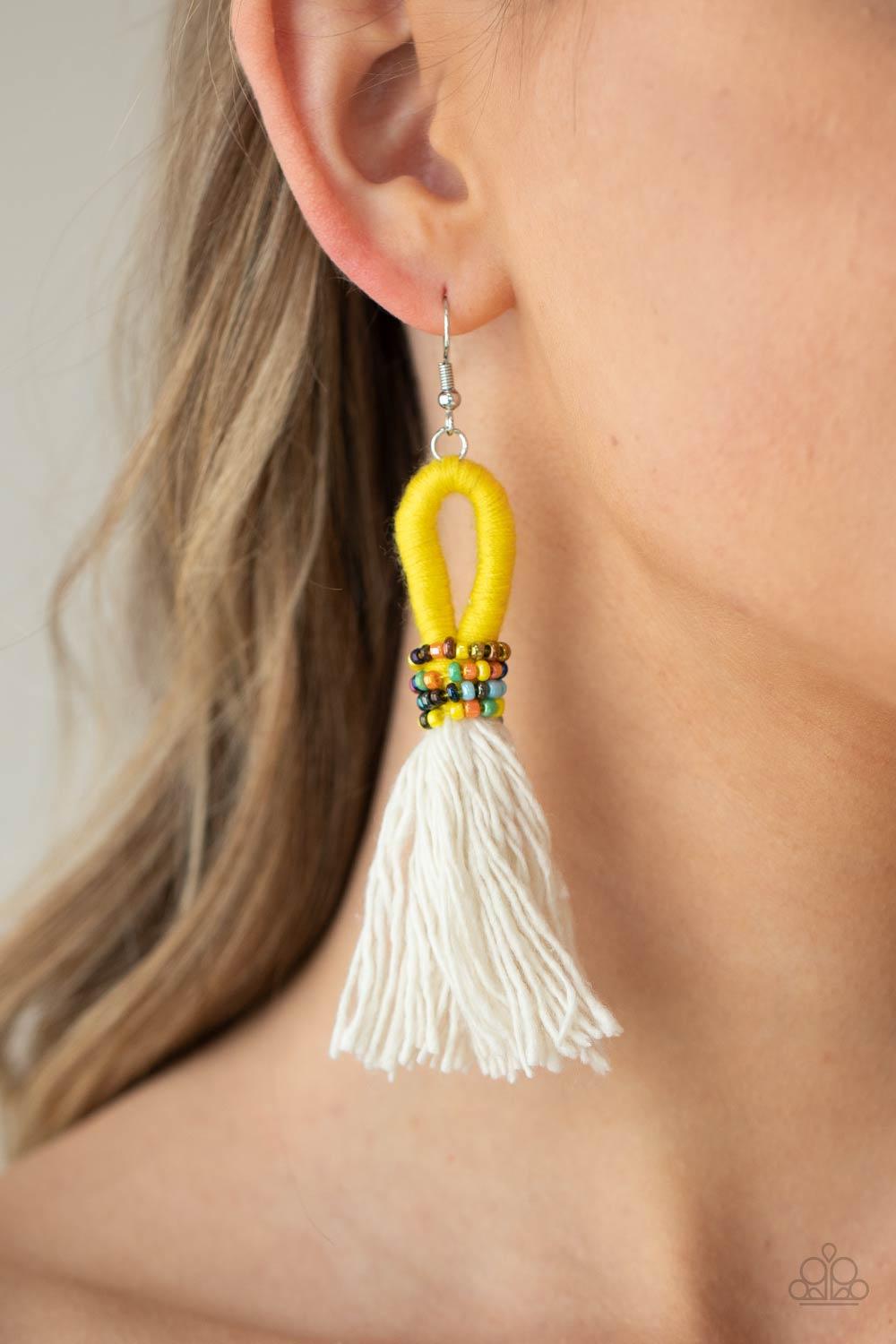 Paparazzi Accessories The Dustup - Yellow A tassel of soft white cotton fans out under rows of brightly colored seed beads. Anchored by a loop of vibrant yellow floss, the eye-catching style swings from the ear for a show-stopping statement. Earring attac