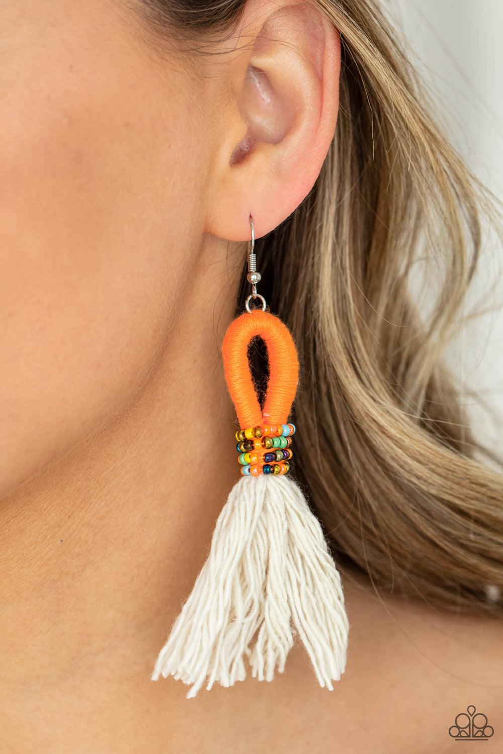Paparazzi Accessories The Dustup - Orange A tassel of soft white cotton fans out under rows of brightly colored seed beads. Anchored by a loop of vibrant orange floss, the eye-catching style swings from the ear for a show-stopping statement. Earring attac