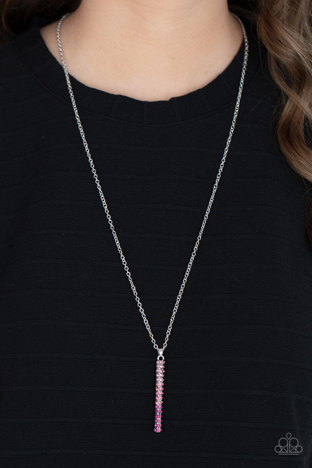 Paparazzi Accessories Tower Of Transcendence - Pink A sparkly collection of spectrum pink rhinestones are encrusted along a silver pendulum that swings along the bottom of a silver chain, creating a glittery ombre effect. Features an adjustable clasp clos