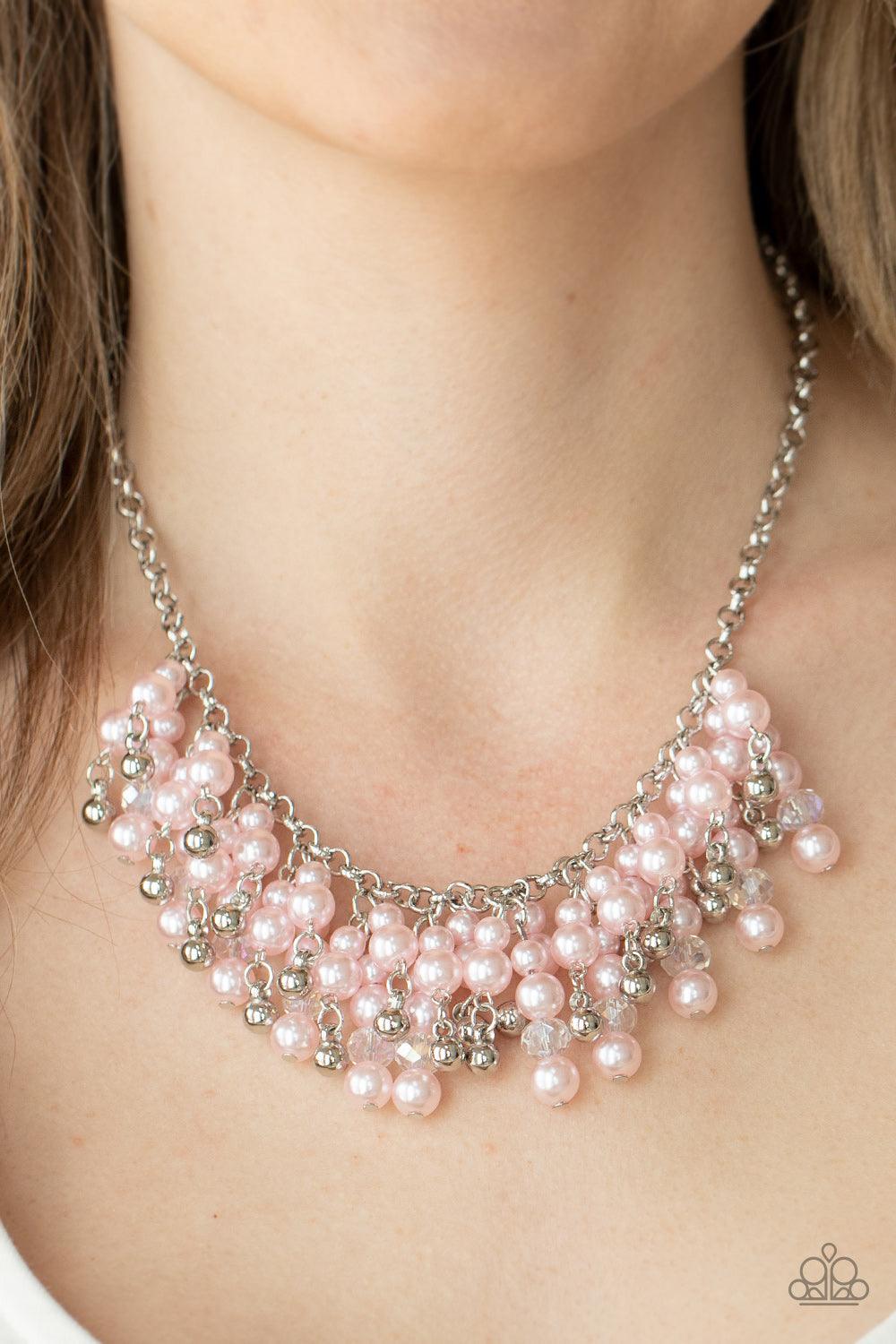 Paparazzi Accessories Champagne Dreams - Pink A bubbly collection of pink pearls, silver beads, and sparkly crystal-like beads are threaded along metallic rods that trickle from the bottom of a shimmery silver chain, creating an elegantly effervescent fri