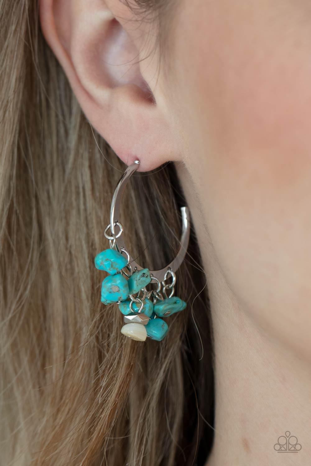 Paparazzi Accessories Gorgeously Grounding - Blue Clusters of turquoise pebbles swing from the bottom of a dainty silver hoop, creating an earthy fringe. A faceted silver and white stone bead swings from the center, adding an ethereal edge. Earring attach