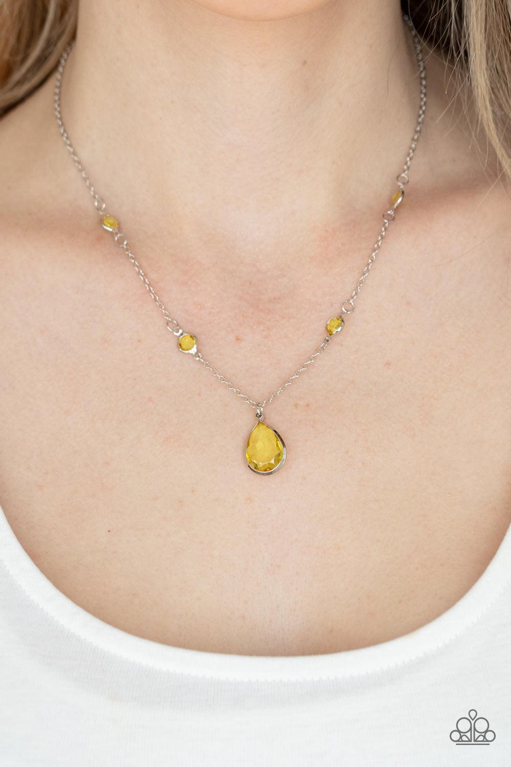 Paparazzi Accessories Romantic Rendezvous - Yellow A glassy yellow teardrop gem encased in a silver frame dips elegantly below the collar. Small round yellow gems accent the silver chain for a delicate and dreamy display. Features an adjustable clasp clos
