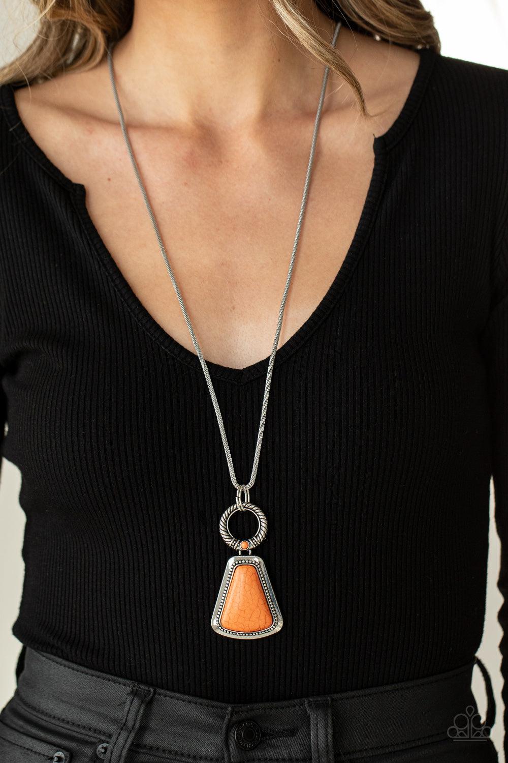 Paparazzi Accessories Stone Prairies - Orange A flared triangular orange stone is pressed into the center of a studded silver frame. A textured ring, dotted with a dainty orange stone, links to the top of the stone creating a dramatically earthy pendant a