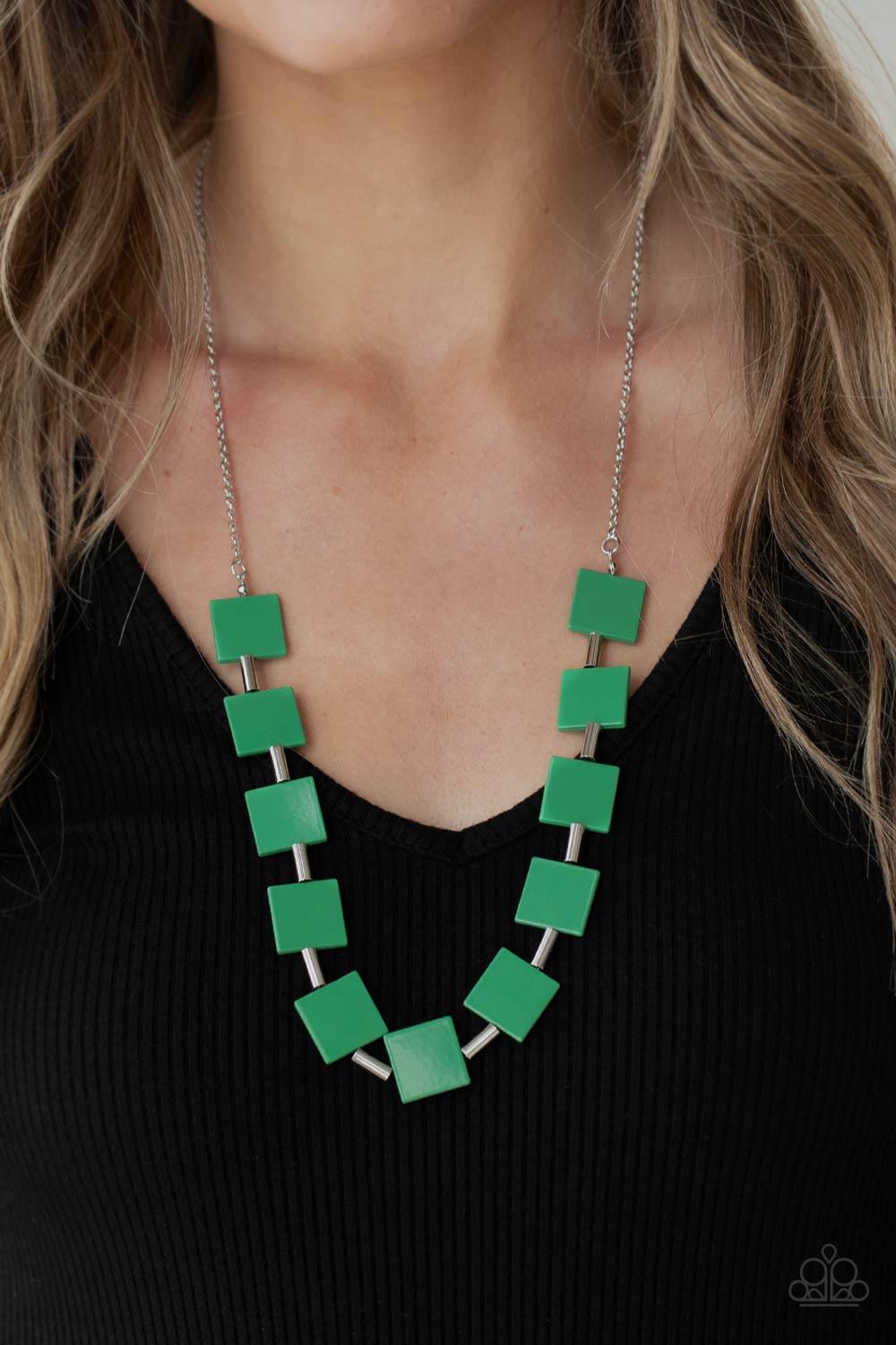 Paparazzi Accessories Hello, Material Girl - Green Vibrant geometric squares painted in the spring Pantone® of Mint flare out along a long silver chain as it drapes along the chest. Sleek silver cylinders separate the square plates, adding cool metallic a