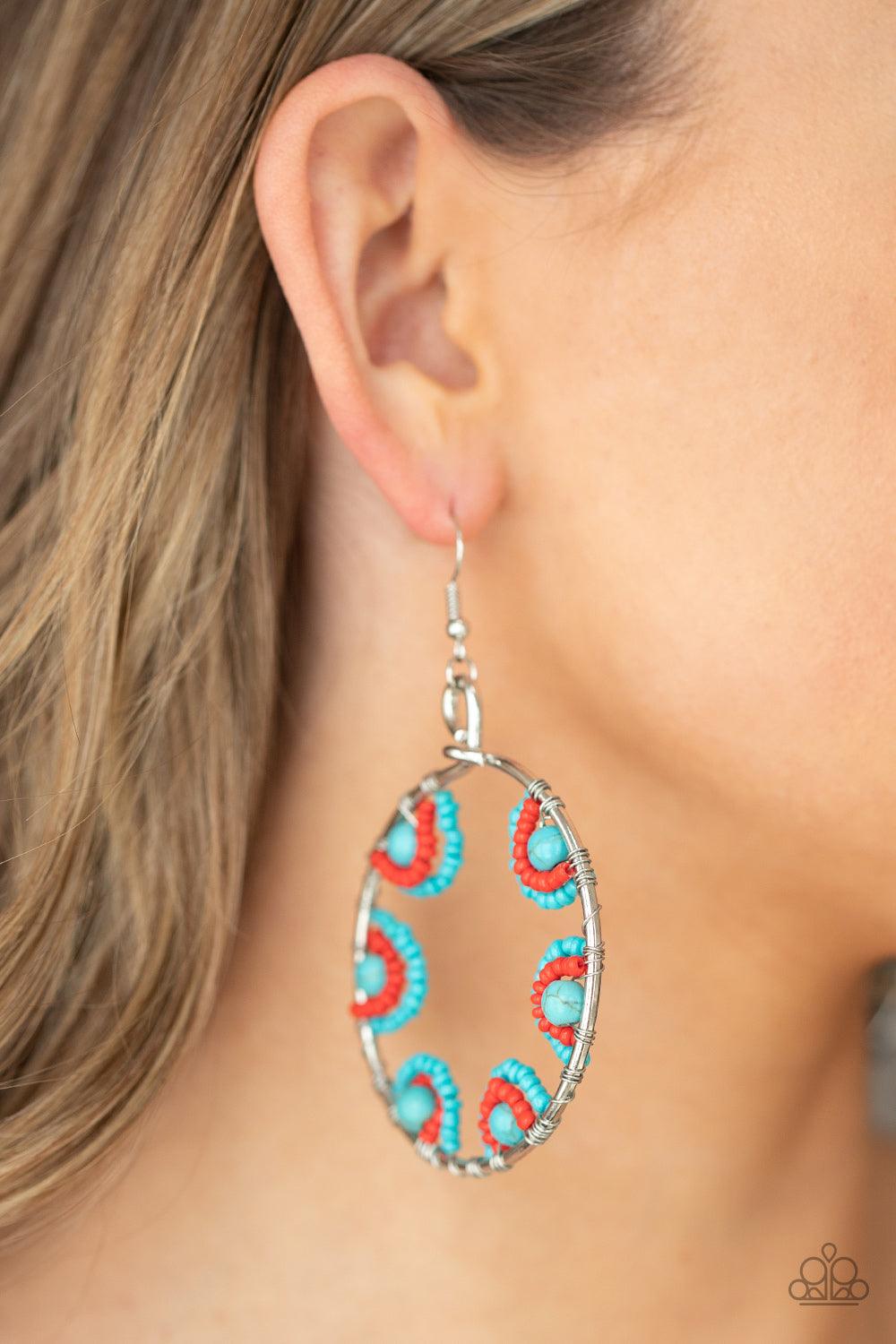 Paparazzi Accessories Off The Rim - Blue Red and turquoise seed beads are threaded on wires and looped over turquoise stones on the inside of a spacious silver hoop. The pattern makes its way around the inside of the circle for an around-the-world air. Ea