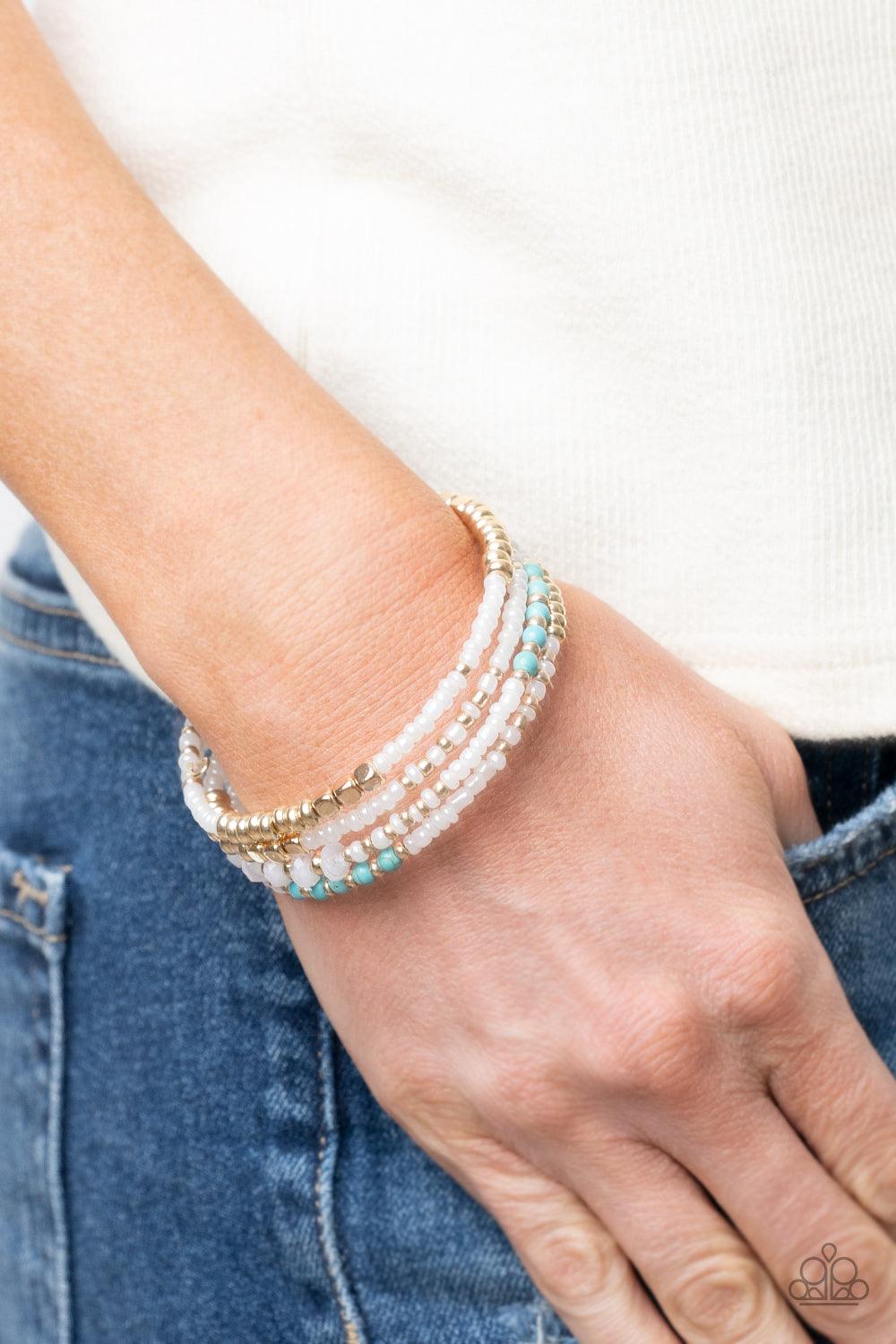 Paparazzi Accessories Infinitely Dreamy - Gold Sections of pearly white seed beads alternate with gold, turquoise, and crystal-like beads in infinite rows. The dreamy colors are threaded along a continuous strand of wire for an infinity wrap-style bracele