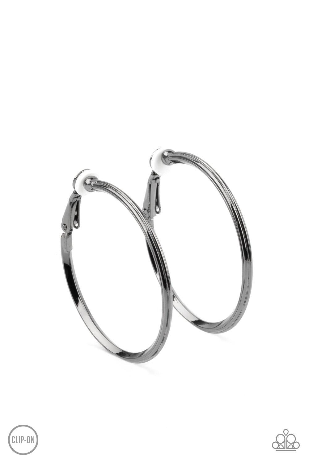 Paparazzi Accessories City Classic - Black Etched in fine lines, a beveled gunmetal hoop curls around the ear for a classic look. Hoop measures approximately 1 1/2" in diameter. Earring attaches to a standard clip-on fitting. Sold as one pair of clip-on e