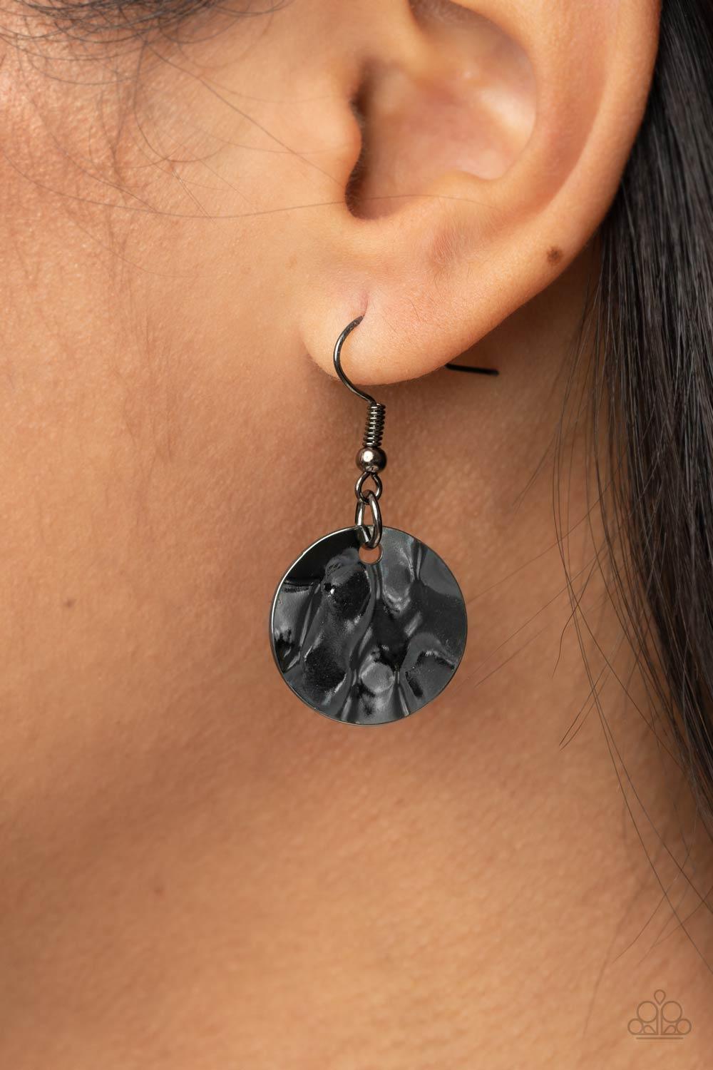 Paparazzi Accessories Alluring Luxe - Black Shining wavy gunmetal discs and black leather discs adorn a trio of lengthened subtly shimmering black cords. Rows of dainty gunmetal cylinders are threaded along the bottom of each cord adding luxurious allure