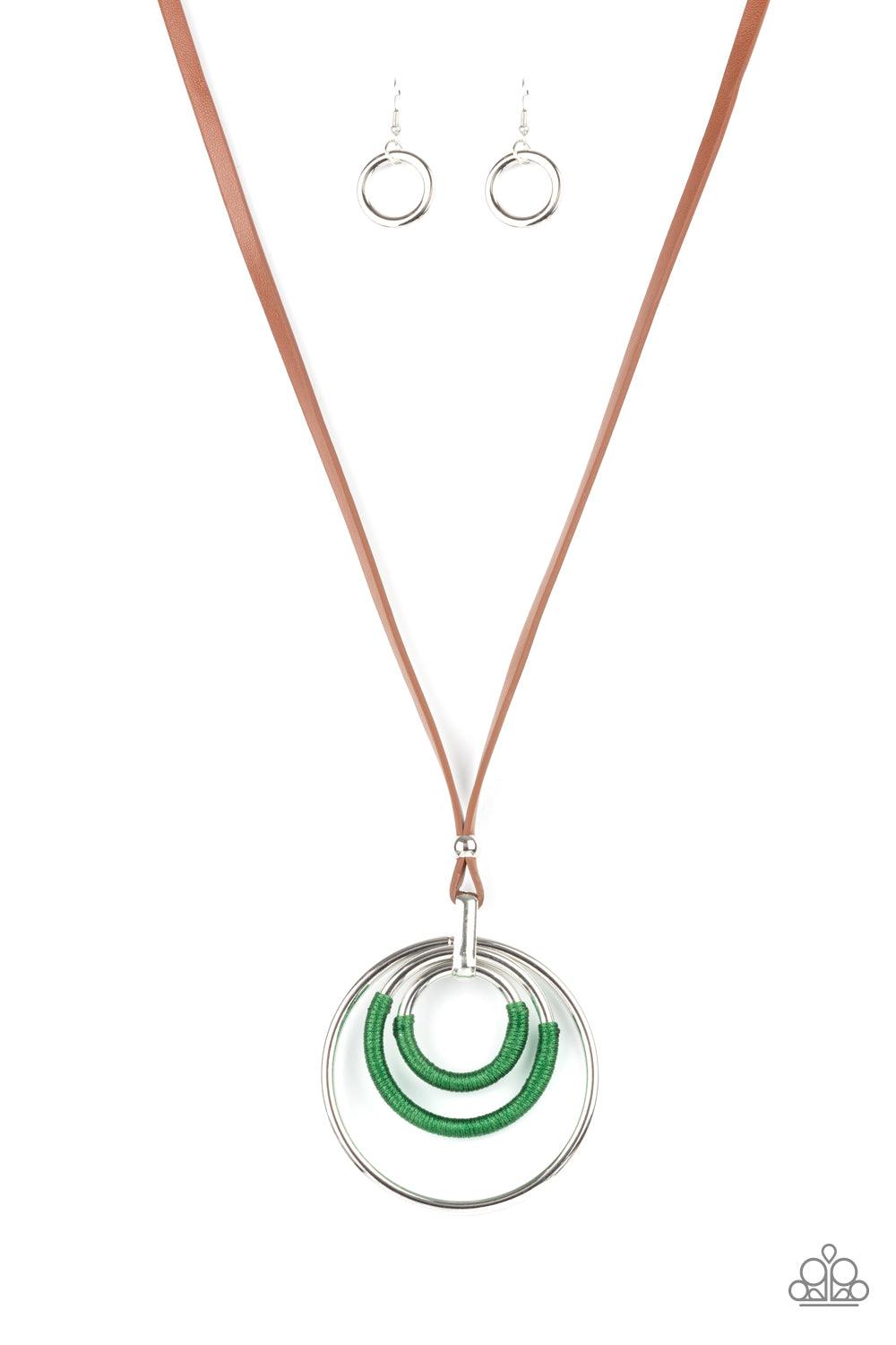 Paparazzi Accessories Hypnotic Happenings - Green An impressive set of thick silver hoops is held together in concentric fashion by a strong silver fitting. Boldly wrapped bright green thread accents two hoops as the hefty pendant suspends from a lengthen