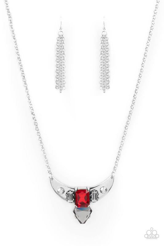 Paparazzi Accessories You the TALISMAN! - Red Pairs of faceted silver beads and glassy white emerald cut gems flank an oversized emerald cut red gem atop an antiqued silver half moon frame. A smoky triangular cut gem adorns the bottom of the pendant, crea