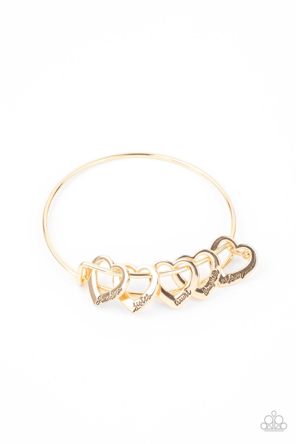 Paparazzi Accessories A Charmed Society - Gold A glistening collection of airy gold heart charms that are stamped in the words, "grandma," "sister," "aunt," "daughter," and "mom," glide along the center of a gold bangle-like bracelet. Features a pronged c