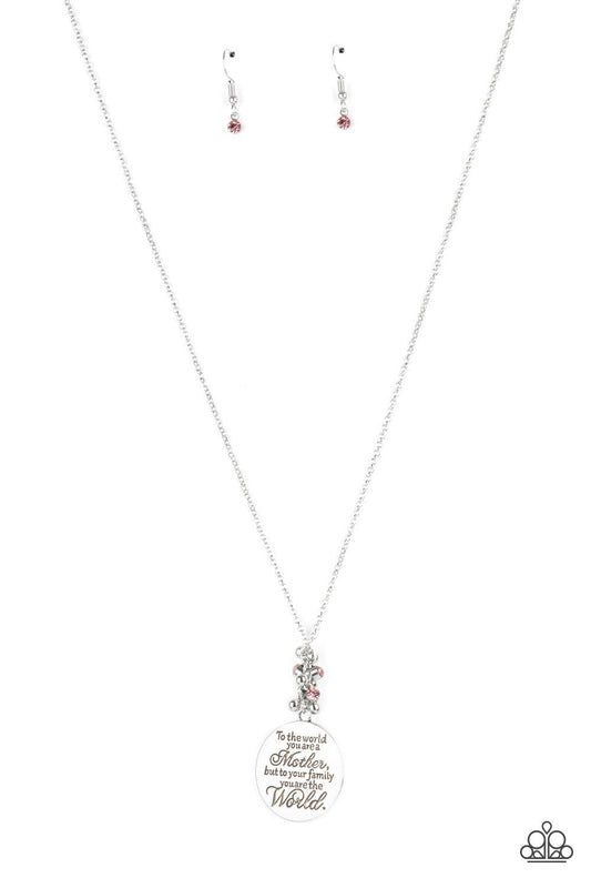 Paparazzi Accessories Maternal Blessings - Pink A silver disc inscribed with the phrase, "To the world you are a Mother, but to your family you are the World," creates a sweet reminder as it falls from a lengthened silver chain. A sprinkle of dainty light