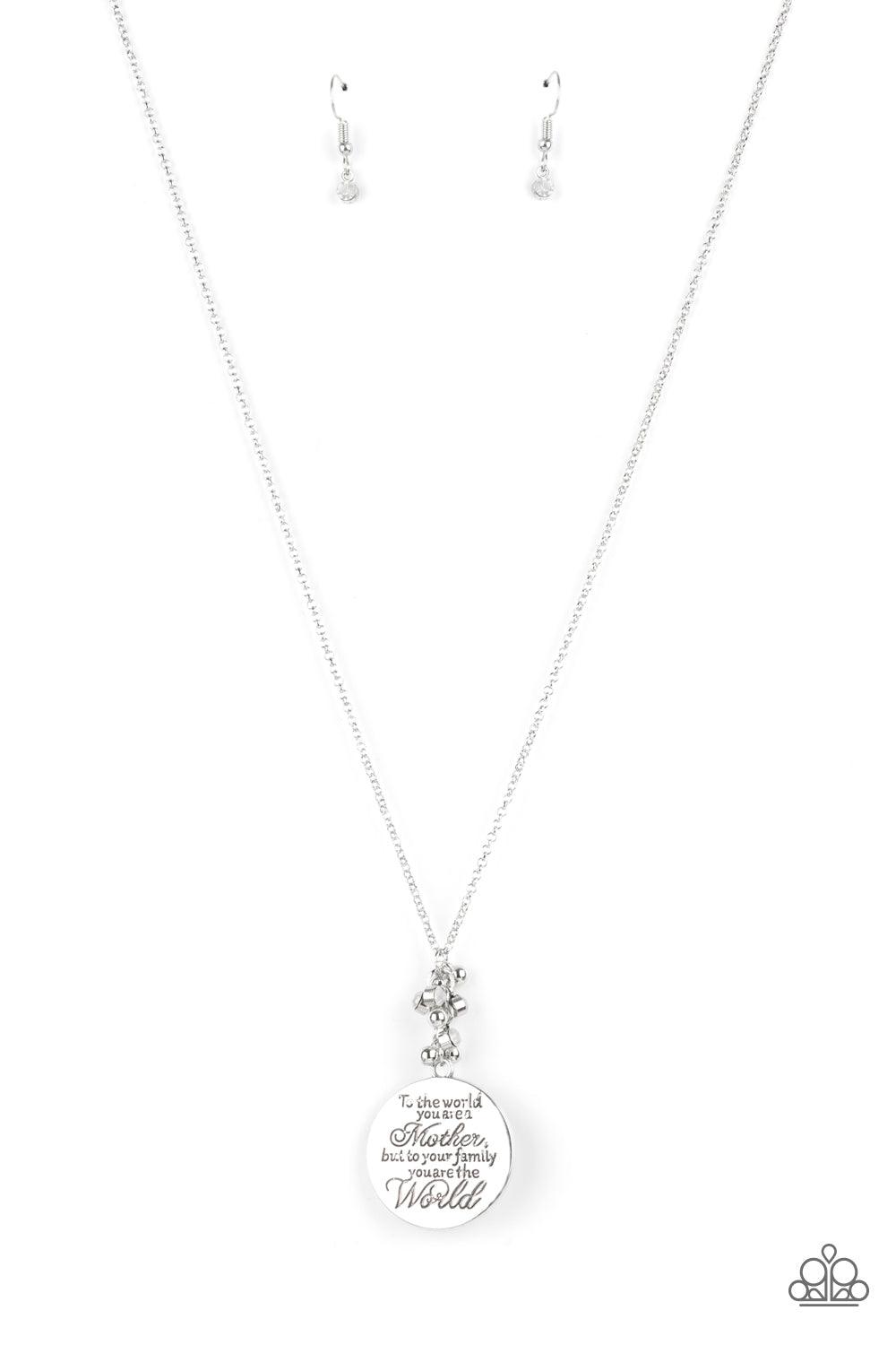 Paparazzi Accessories Maternal Blessings - White A silver disc inscribed with the phrase, "To the world you are a Mother, but to your family you are the World," creates a sweet reminder as it falls from a lengthened silver chain. A sprinkle of dainty whit