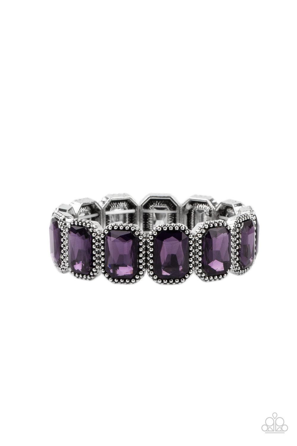 Paparazzi Accessories Studded Smolder - Purple Oversized emerald style purple gems are encased in antiqued studded frames that are threaded along stretchy bands around the wrist, creating a smoldering centerpiece. Sold as one individual bracelet. Jewelry