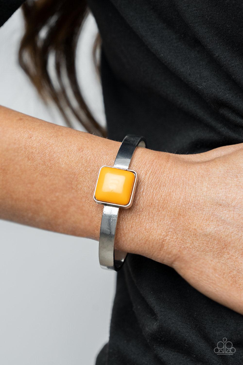 Paparazzi Accessories Prismatically Poppin - Orange A square Marigold bead is pressed into the center of a sleek silver frame that sits atop a dainty silver cuff, creating a bold pop of color atop the wrist. Sold as one individual bracelet. Jewelry