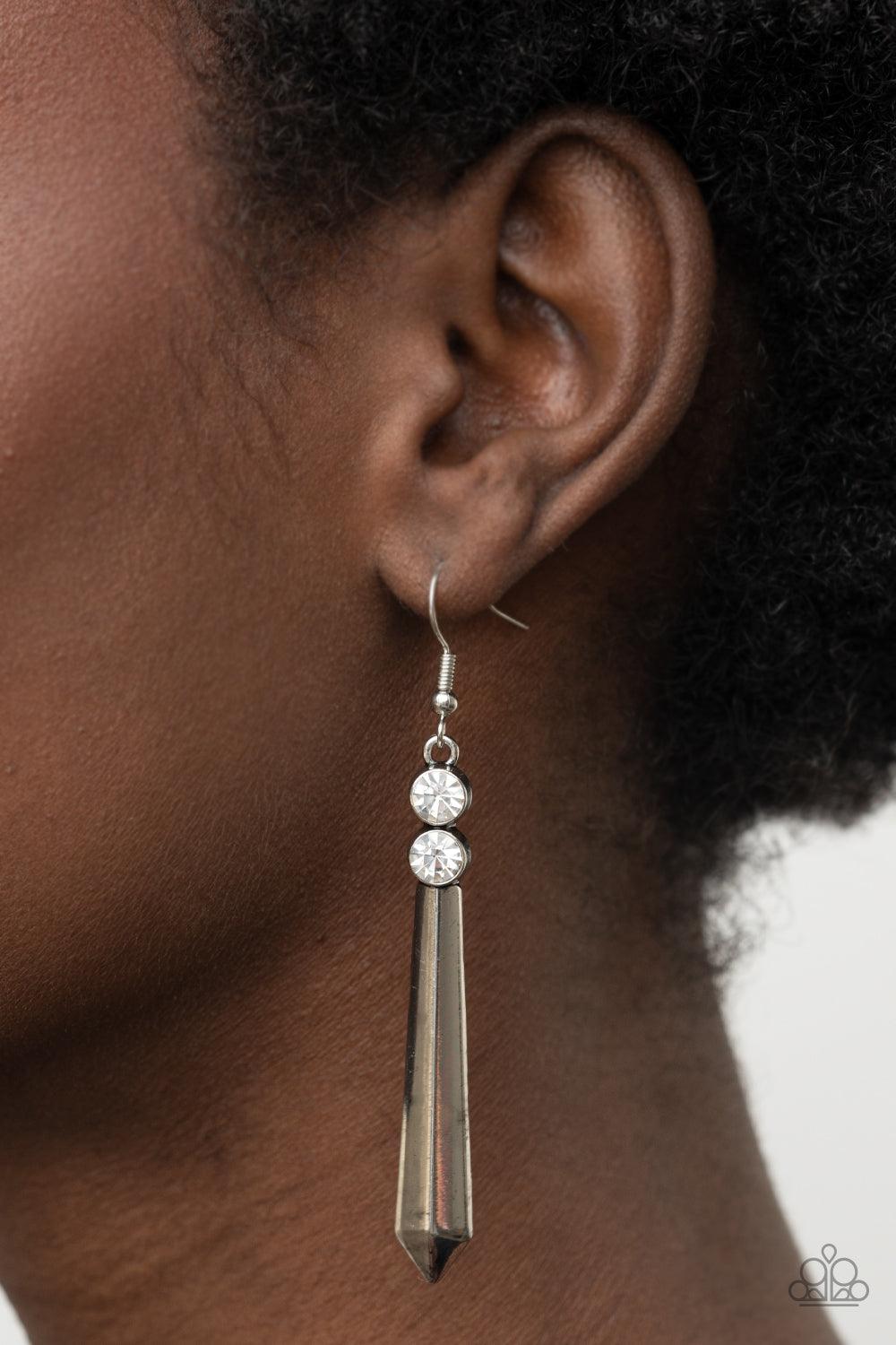 Paparazzi Accessories Sparkle Stream - White A pair of glittery white rhinestones crowns a flared silver rod, creating a sharp-looking lure. Earring attaches to a standard fishhook fitting. Sold as one pair of earrings. Jewelry