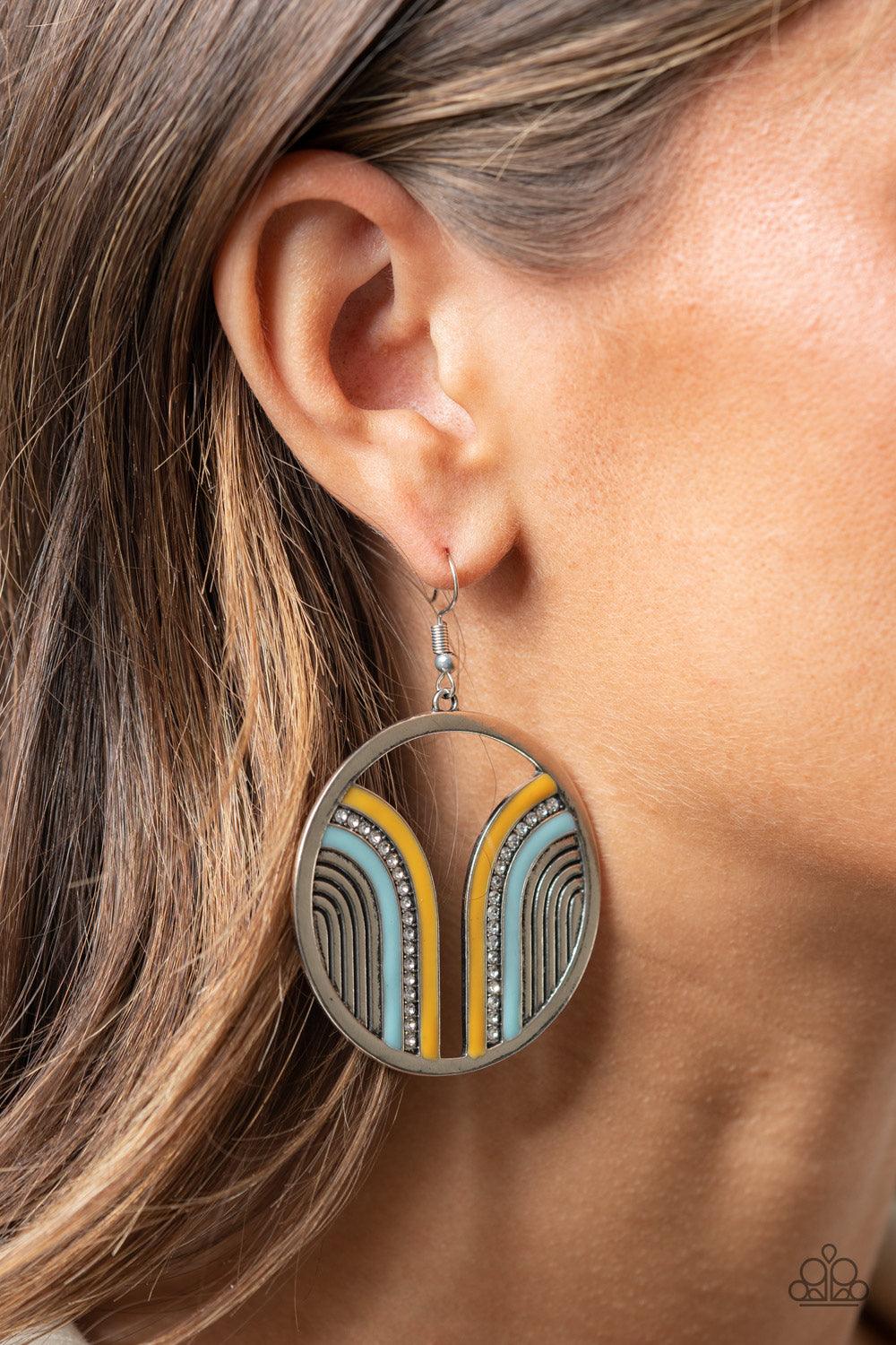 Paparazzi Accessories Delightfully Deco - Multi Infused with a glittery row of white rhinestones, shiny Cerulean and Illuminating arcs curve into juxtaposed frames inside a classic silver hoop, creating a colorful art deco inspired centerpiece. Earring at