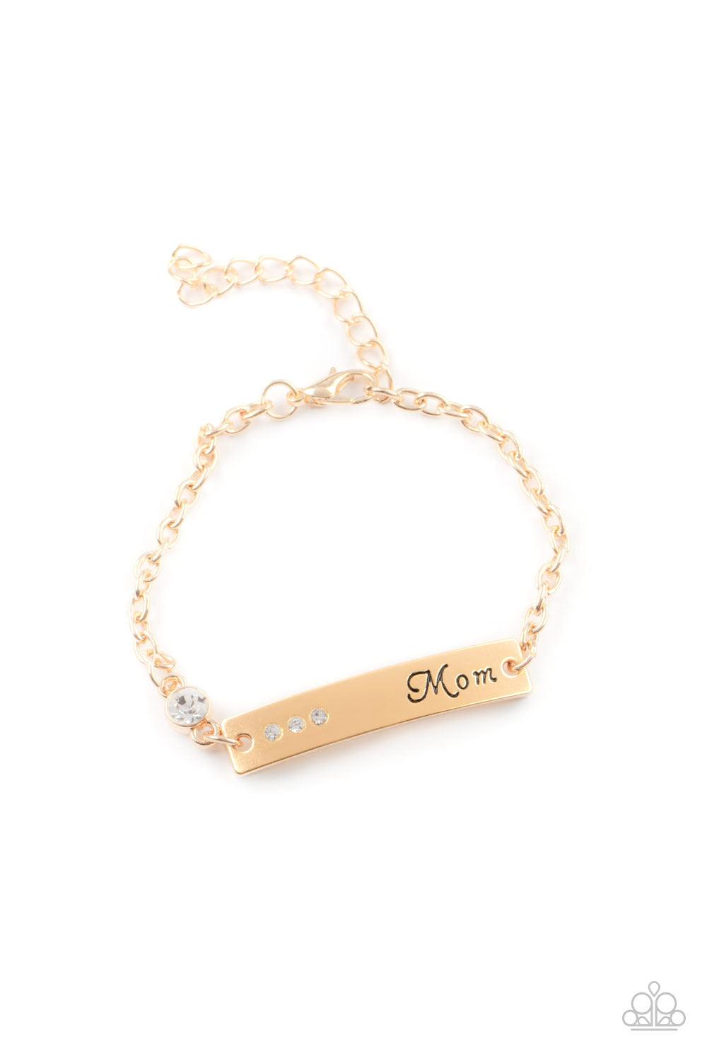 Paparazzi Accessories Mom Always Knows - Gold Infused with a glittery white rhinestone charm, a curved gold plate is dotted in dainty white rhinestones and stamped in the word, "Mom," as it delicately attaches to a dainty gold chain around the wrist for a