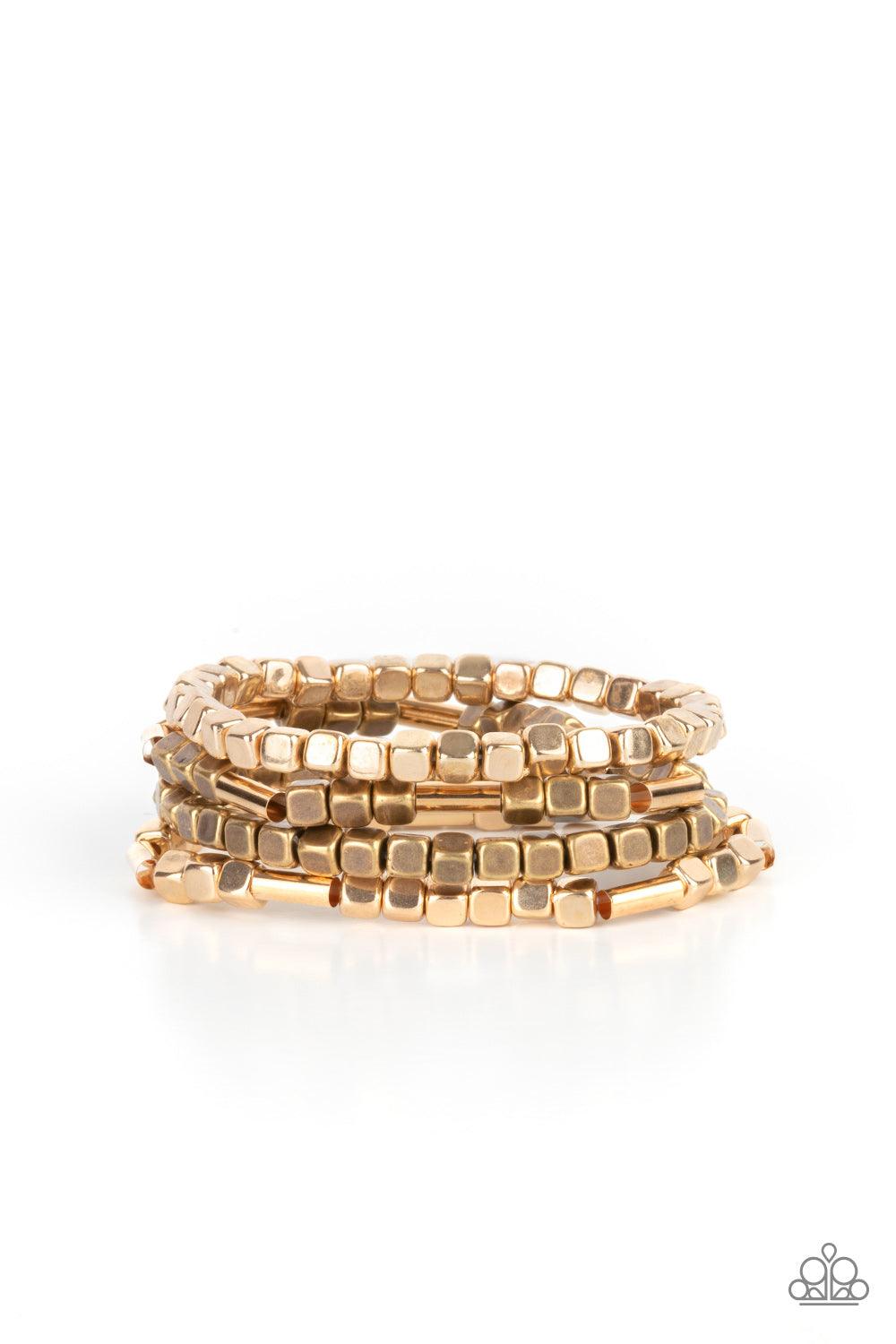 Paparazzi Accessories Metro Materials - Multi Lightweight and flirty, two strands of gold and brass square beads interspersed with gold cylinders, are paired with two strands of gold and brass cubes. The four stretchy bracelets come together to create an