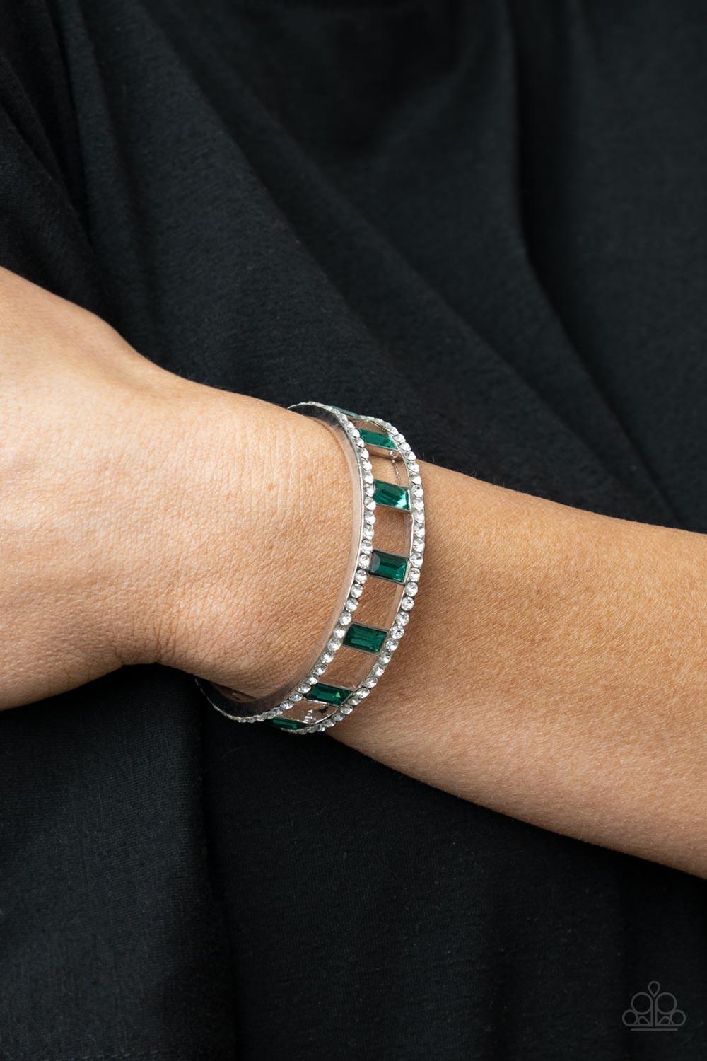 Paparazzi Accessories Industrial Icing - Green Bands of glittery white rhinestones overlaid on silver frames create an airy channel-like framework. Elegant baguette style cut green gems, connected to the glittery framework, circle around the wrist for a r