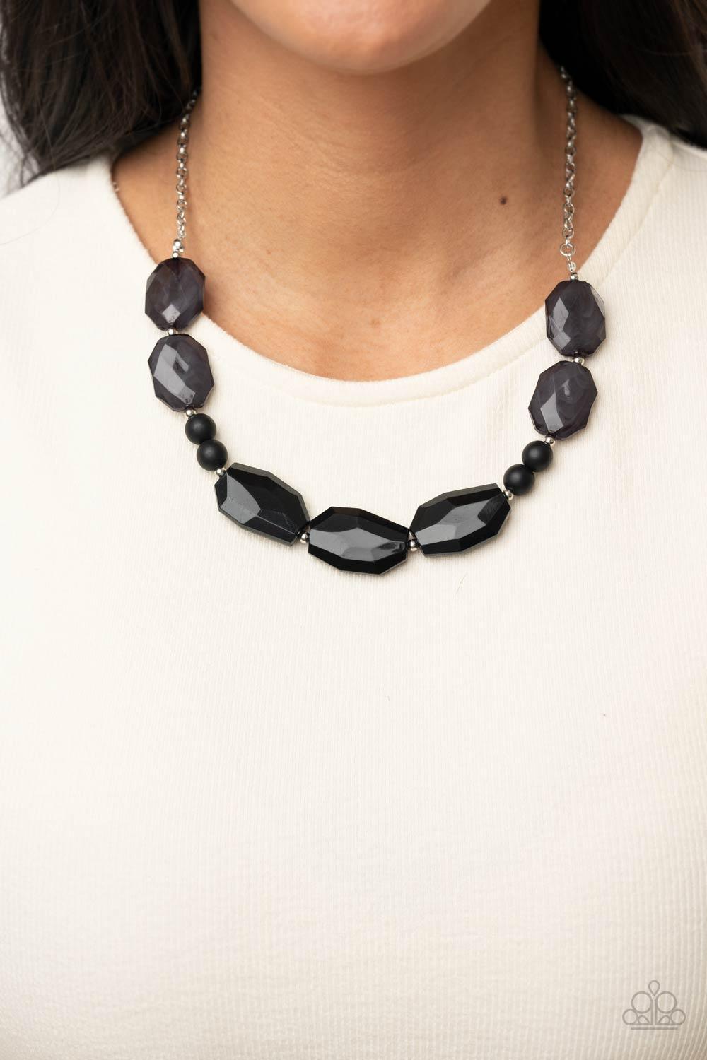 Paparazzi Accessories Melrose Melody - Black A series of opaque and faceted black gem-like beads are threaded along an invisible wire. Dainty silver beads add shining accents as they traverse across the collar on a silver chain in a classically melodic di