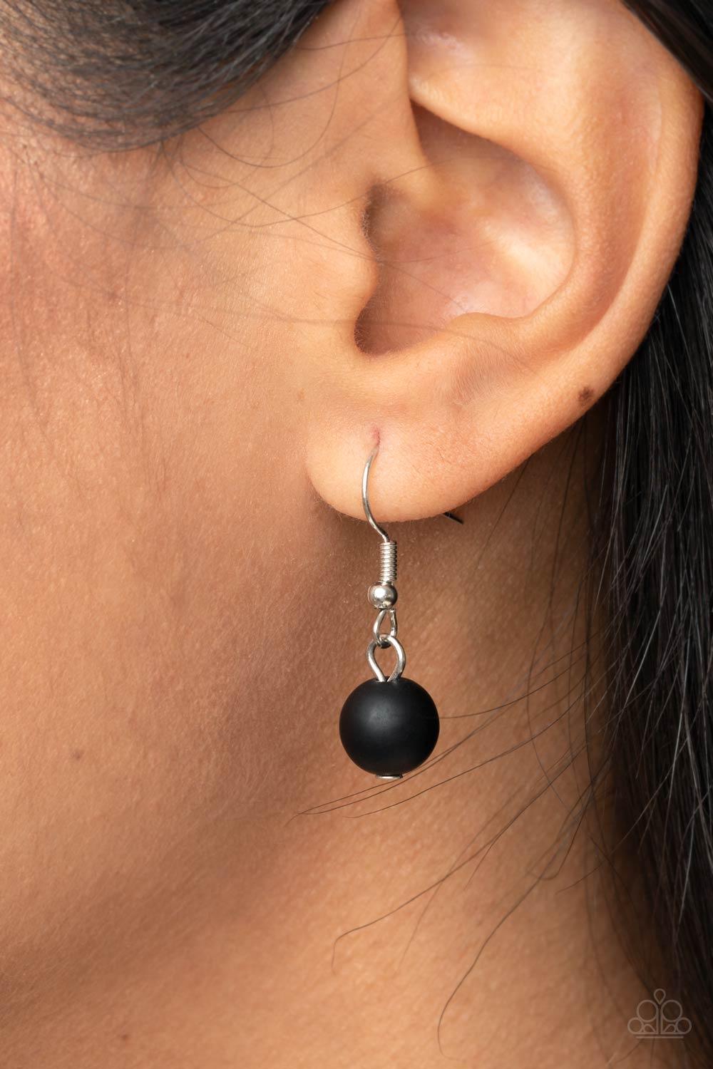 Paparazzi Accessories Melrose Melody - Black A series of opaque and faceted black gem-like beads are threaded along an invisible wire. Dainty silver beads add shining accents as they traverse across the collar on a silver chain in a classically melodic di