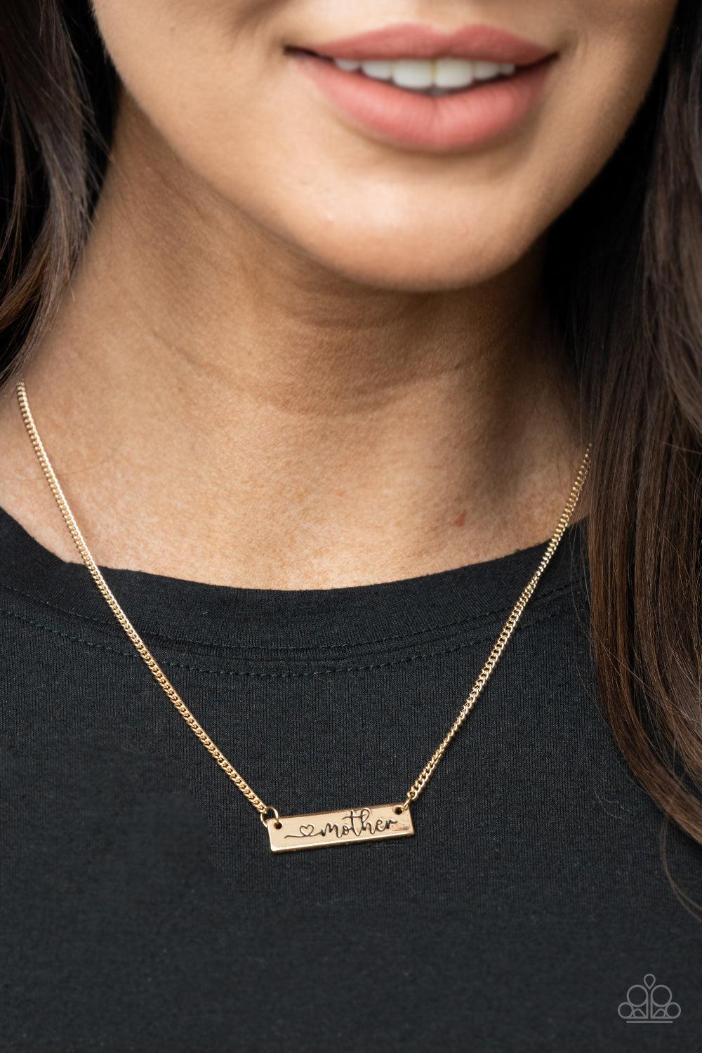 Paparazzi Accessories Joy Of Motherhood - Gold Stamped in a heart and the word, "Mother," a glistening gold plate is suspended by a classic gold chain below the collar, creating a whimsy sentimental pendant. Features an adjustable clasp closure. Sold as o