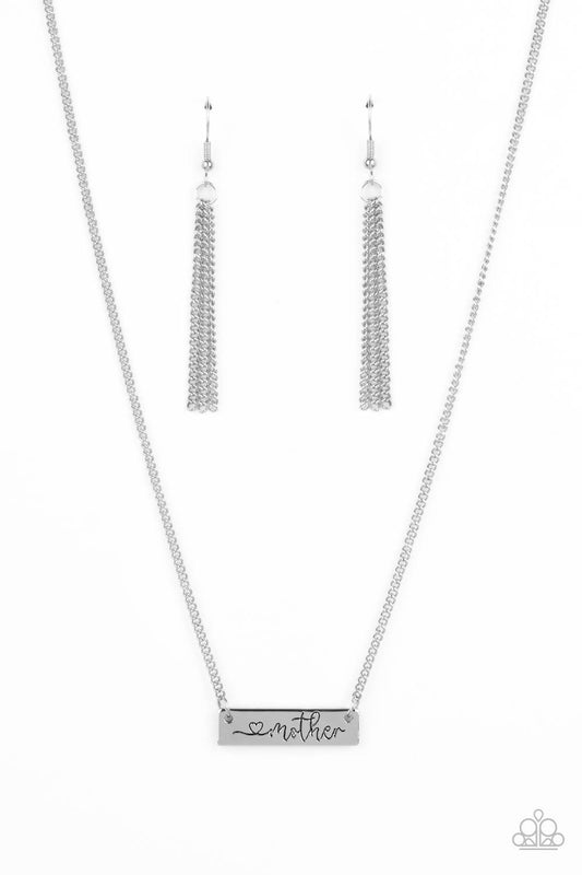 Paparazzi Accessories Joy Of Motherhood - Silver Stamped in a heart and the word, "Mother," a glistening silver plate is suspended by a classic silver chain below the collar, creating a whimsy sentimental pendant. Features an adjustable clasp closure. Sol