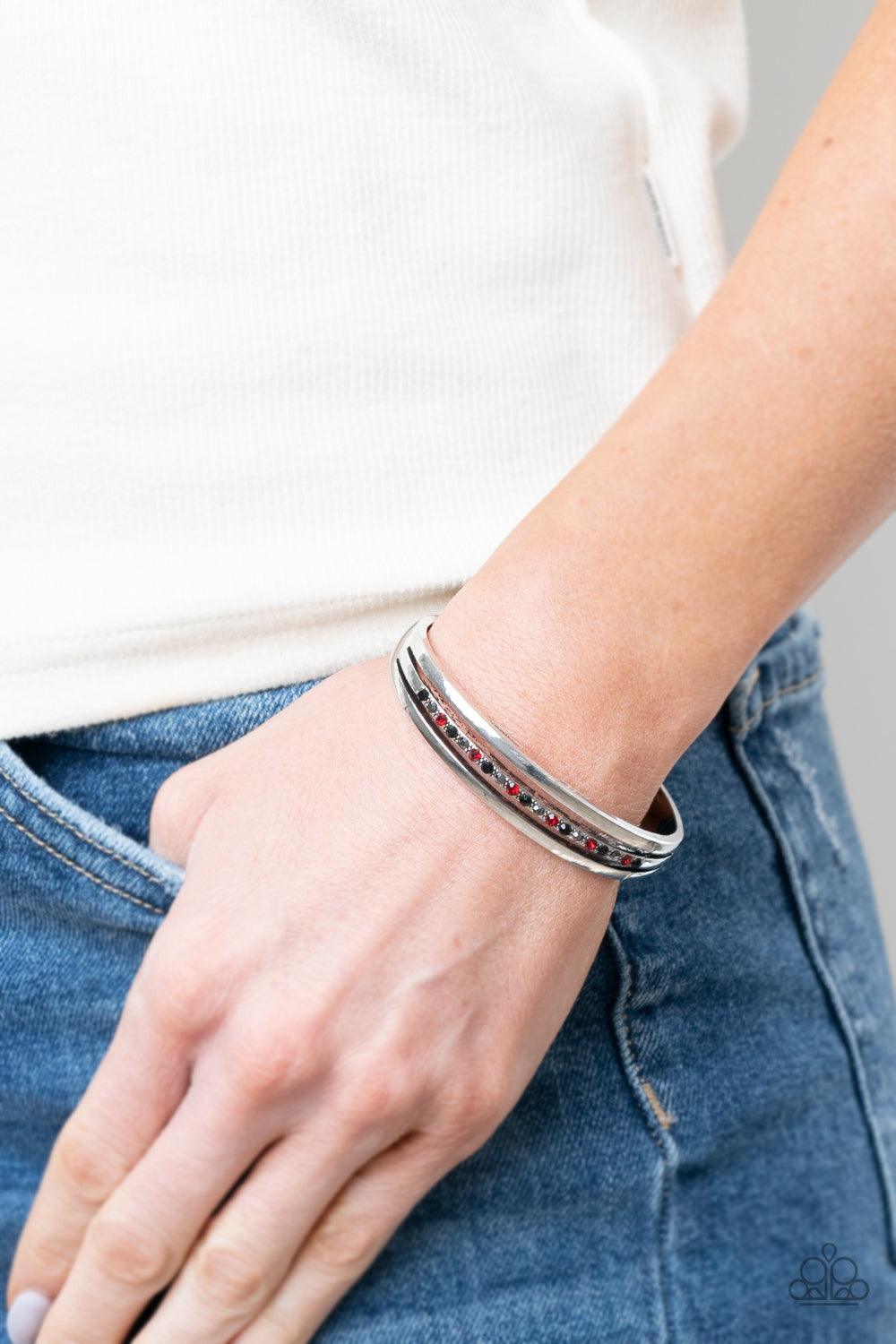 Paparazzi Accessories A Point Of Pride - Multi Two glistening silver bars flank a row of black, red, and hematite rhinestones, coalescing into a dainty layered cuff around the wrist for a dash of refined edge. Sold as one individual bracelet. Jewelry