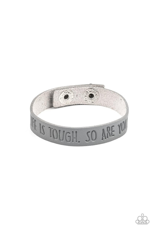 Paparazzi Accessories Life is Tough - Silver A dainty gray leather band is stamped in the phrase, "Life is tough. So Are You.," creating an inspiring centerpiece around the wrist. Features an adjustable snap closure. Sold as one individual bracelet. Jewel