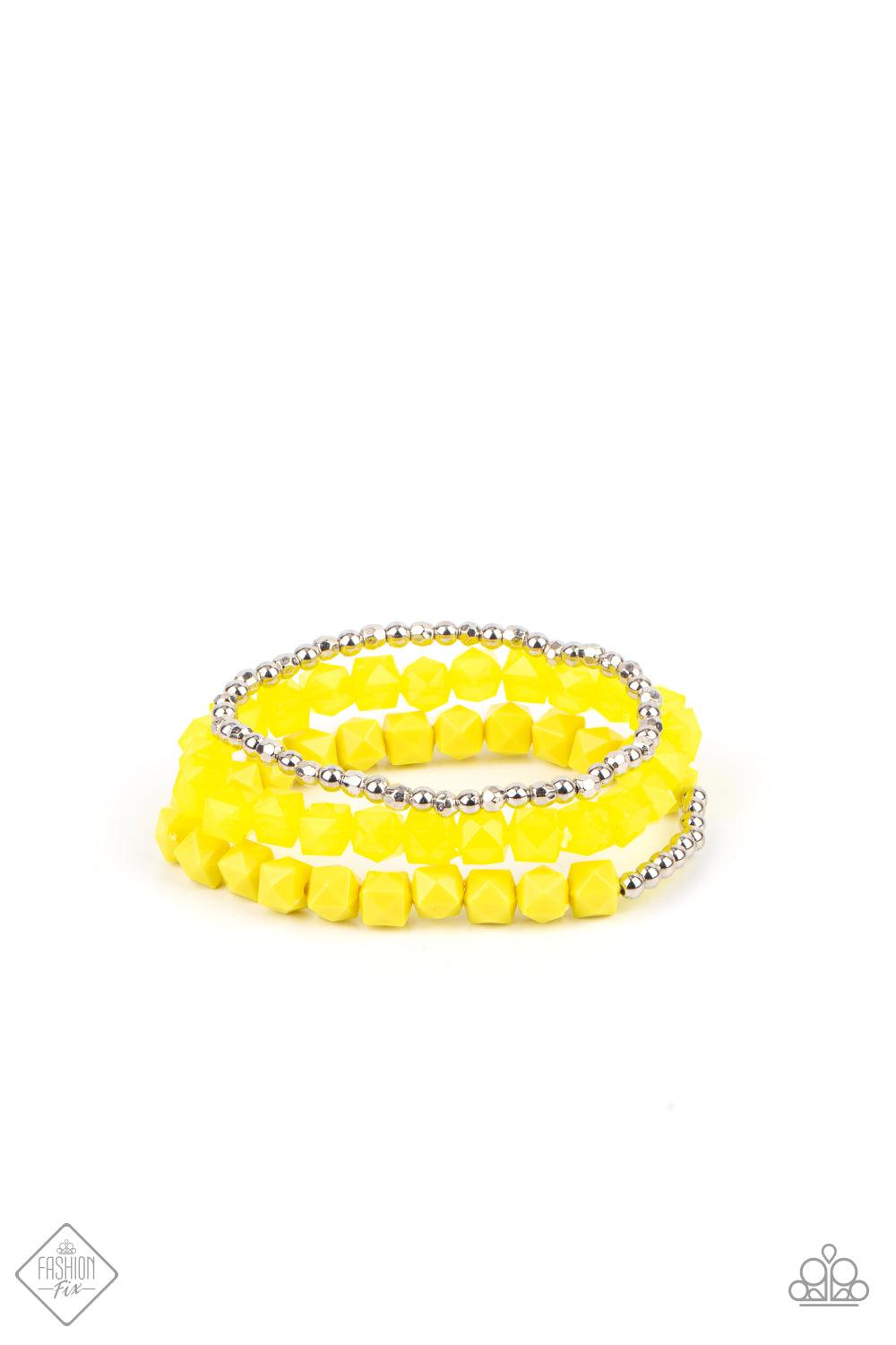 Paparazzi Accessories Vacay Vagabond - Yellow Infused with a strand of round and faceted silver beads, faceted rows of solid and opaque Illuminating cube beads are threaded along stretchy bands, wrapping around the wrist for an edgy pop of color. Sold as