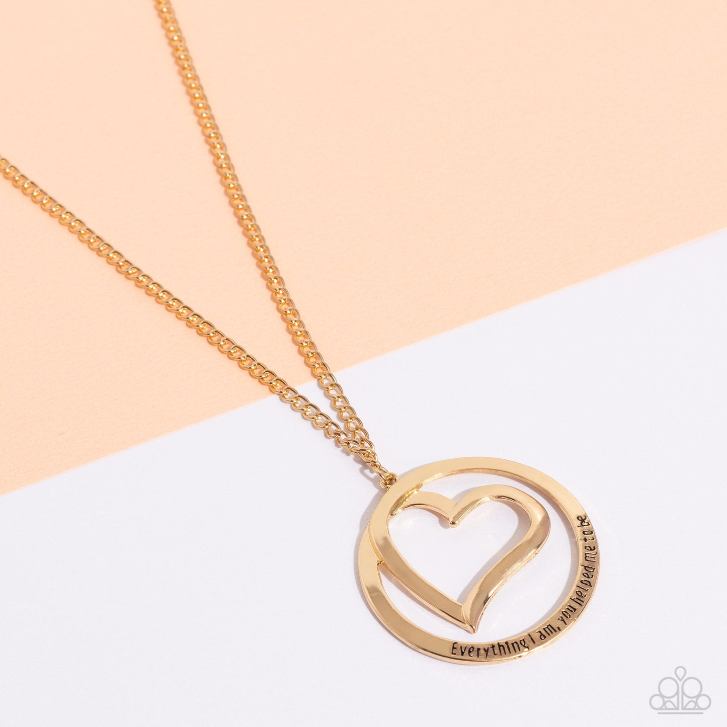 Paparazzi Accessories Positively Perfect - Gold An airy gold circular frame wraps around to enclose a gold heart. The frame is inscribed with the words, "Everything I am, you helped me to be," for a positively lovely pendant swinging from a lengthened gol