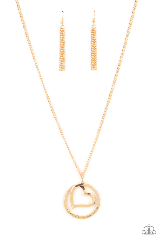 Paparazzi Accessories Positively Perfect - Gold An airy gold circular frame wraps around to enclose a gold heart. The frame is inscribed with the words, "Everything I am, you helped me to be," for a positively lovely pendant swinging from a lengthened gol
