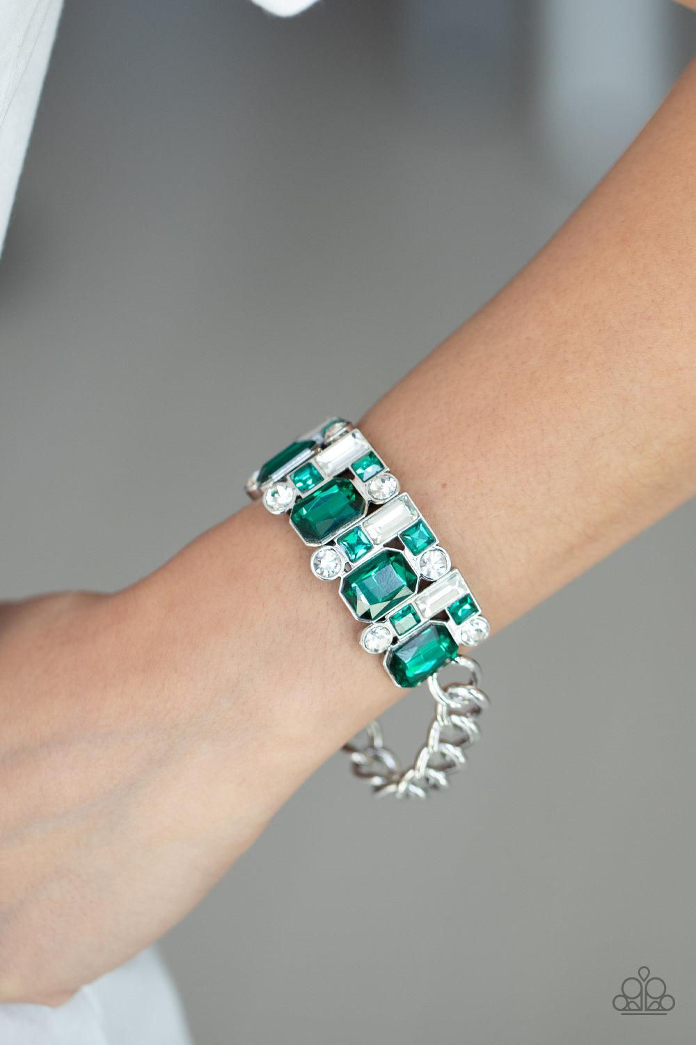 Paparazzi Accessories Urban Crest - Green A mismatched collision of green and white rhinestone encrusted frames are threaded along a stretchy band that attaches to a chunky strand of silver chain, creating a jaw-dropping dazzle across the front of the wri