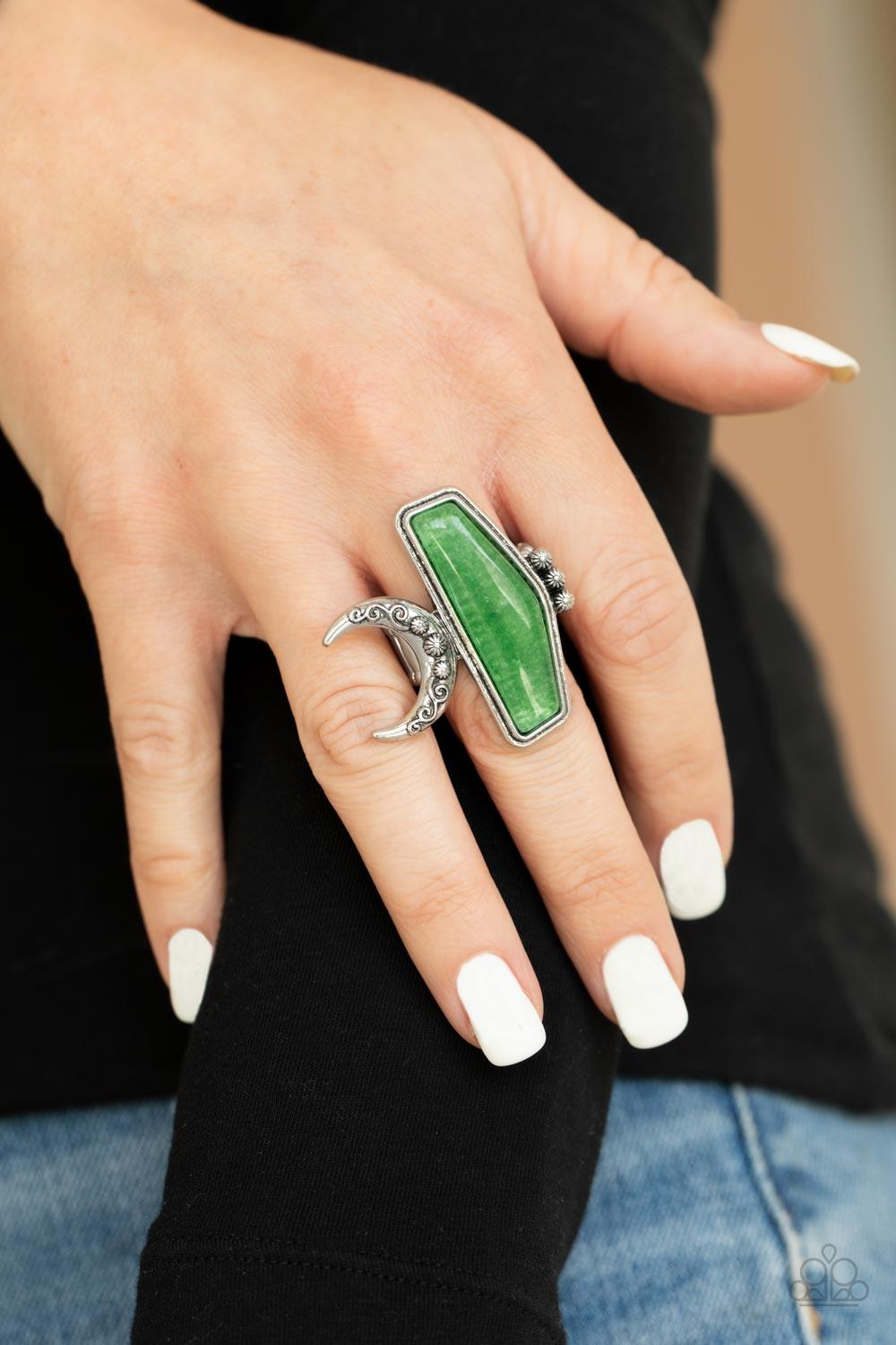 Paparazzi Accessories Cosmic Karma - Green Encased in a raised silver fitting, a geometric jade stone is flank by a decorative row of silver studs and an ornate half moon frame for a seasonal statement. The oversized frame is attentional, creating the ill