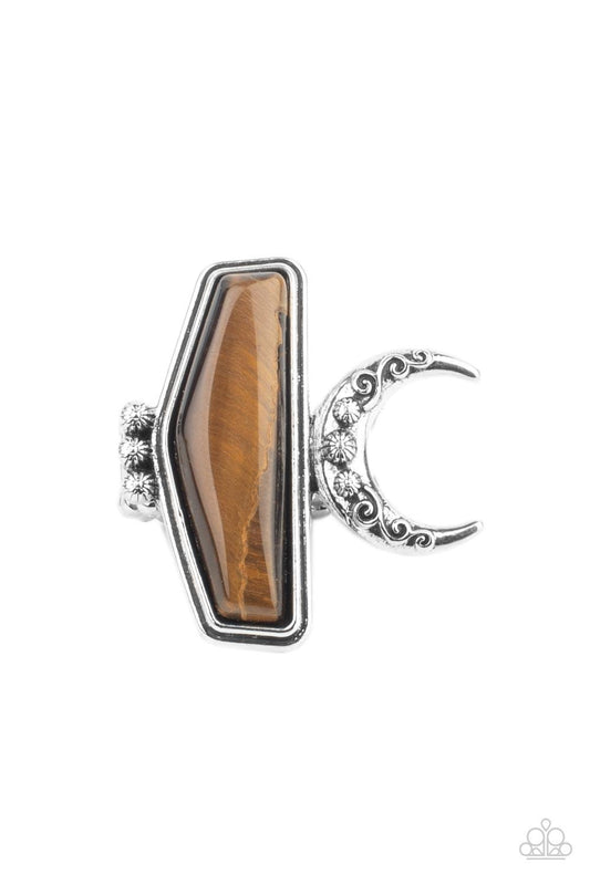 Paparazzi Accessories Cosmic Karma - Brown Encased in a raised silver fitting, a geometric tiger's eye stone is flank by a decorative row of silver studs and an ornate half moon frame for a seasonal statement. The oversized frame is attentional, creating
