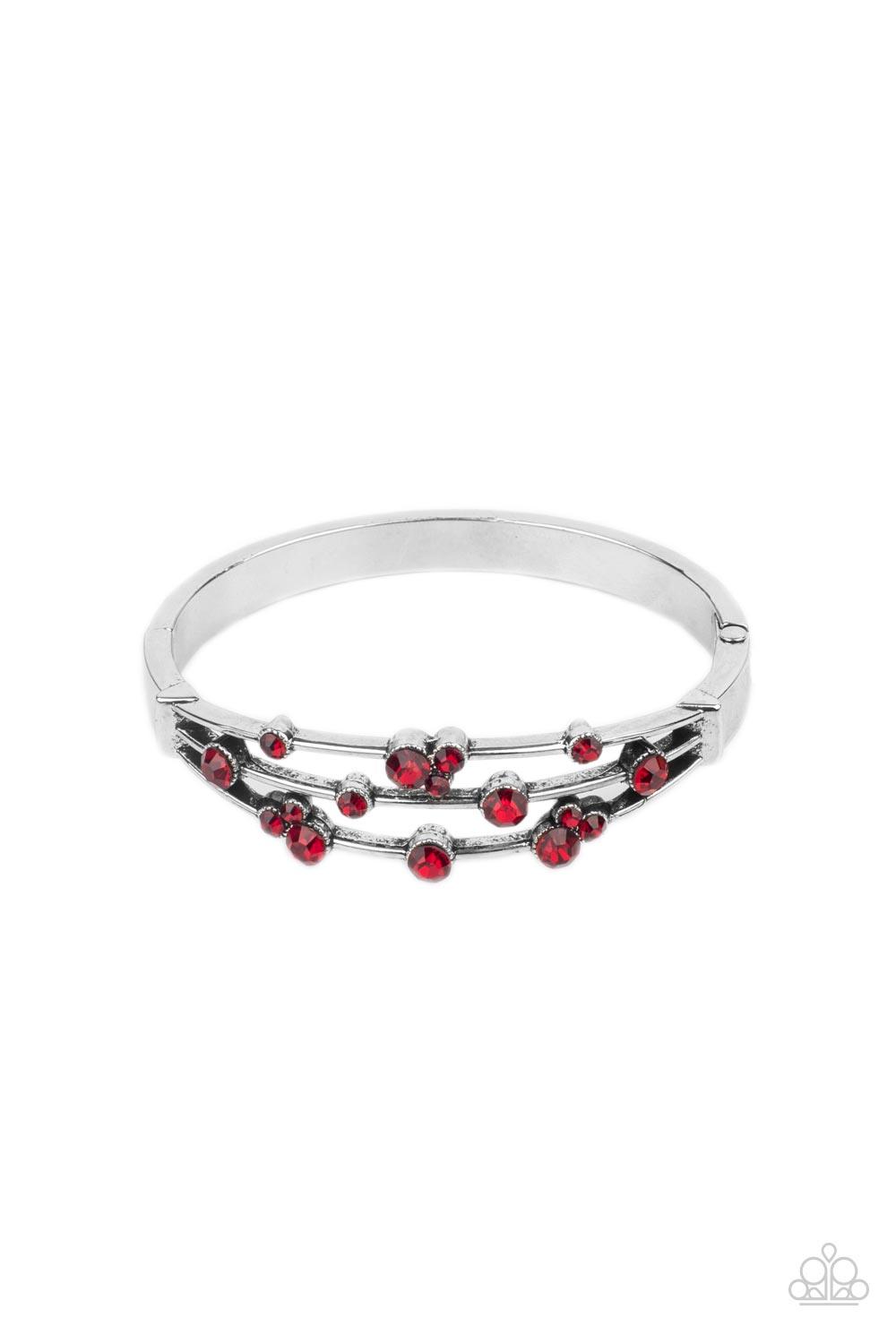 Paparazzi Accessories Cosmic Candescence - Red A smattering of fiery red rhinestones adorn three silver bars that coalesce into a versatile silver cuff-like bangle around the wrist. Features a hinged closure. Sold as one individual bracelet. Jewelry