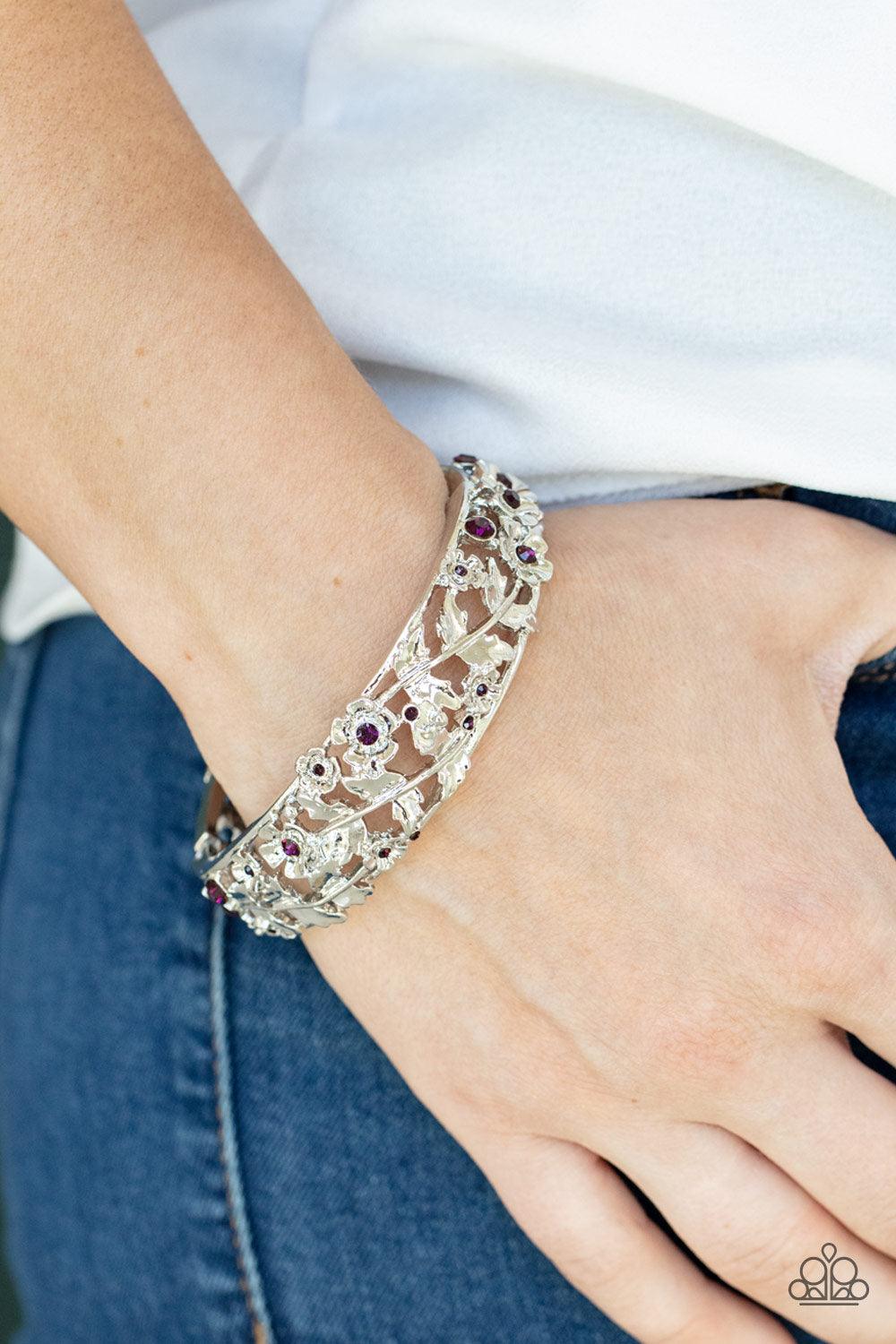 Paparazzi Accessories Ripe for the Picking - Purple Dotted with dainty purple rhinestone centers, flowering leafy silver vines bloom into two oversized silver frames that delicately hinge into a versatile bangle-like bracelet. Features a hinged closure. S