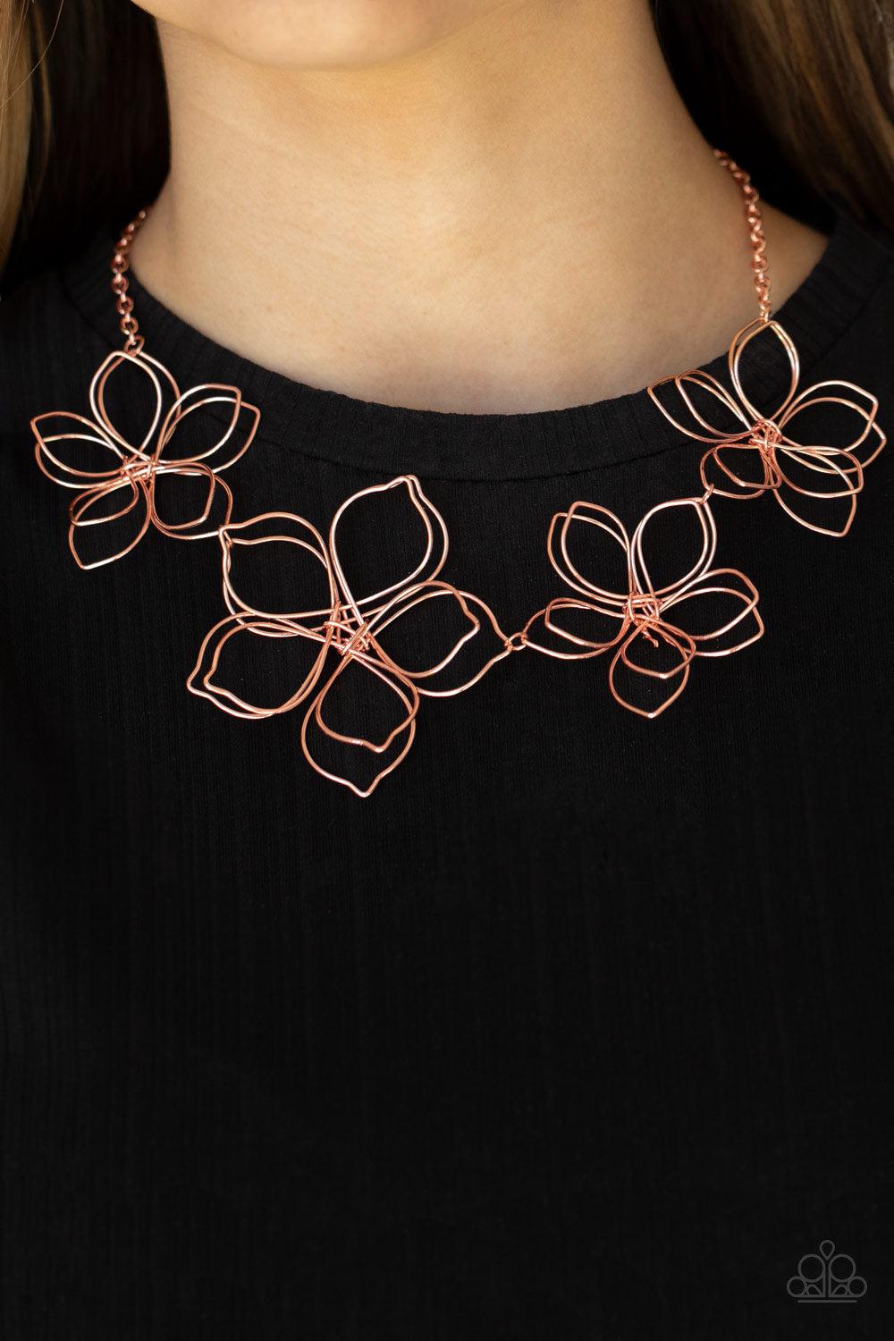 Paparazzi Accessories Flower Garden Fashionista - Copper Shiny copper wire delicately twists into oversized blossoms. Varying in size, the airy floral frames delicately link into an asymmetrical display as the layered frames elegantly pop beneath the coll
