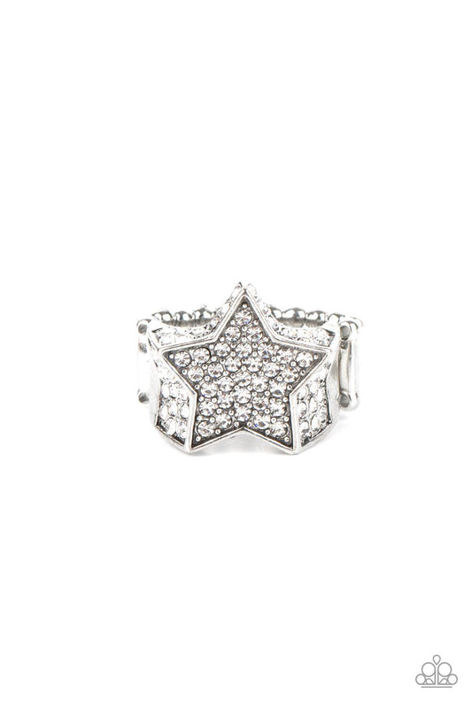 Paparazzi Accessories Here Come The Fireworks - White Encrusted in glittery white rhinestones, a sparkly silver star joins with a thick band of blinding white rhinestones. The edges of the star are embellished in additional white rhinestones, creating a s