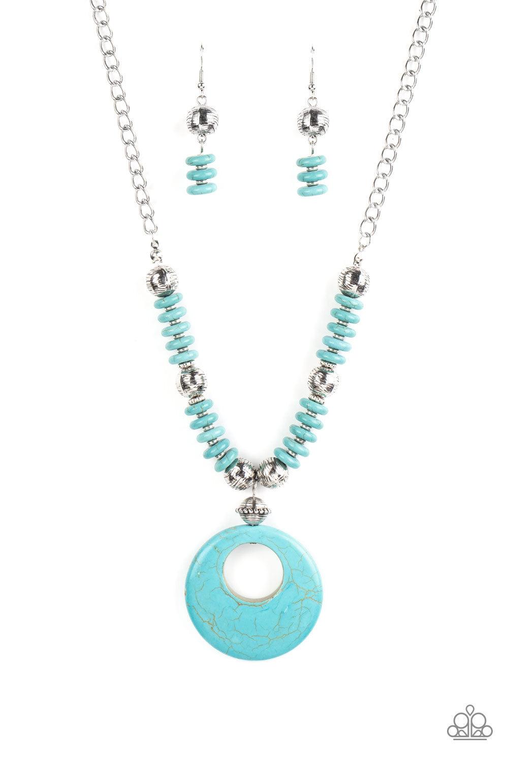Paparazzi Accessories Oasis Goddess - Blue Infused with dainty silver accents, mismatched silver beads and turquoise stone discs are threaded along an invisible wire below the collar. An oversized turquoise stone pendant swings from the center of the eart